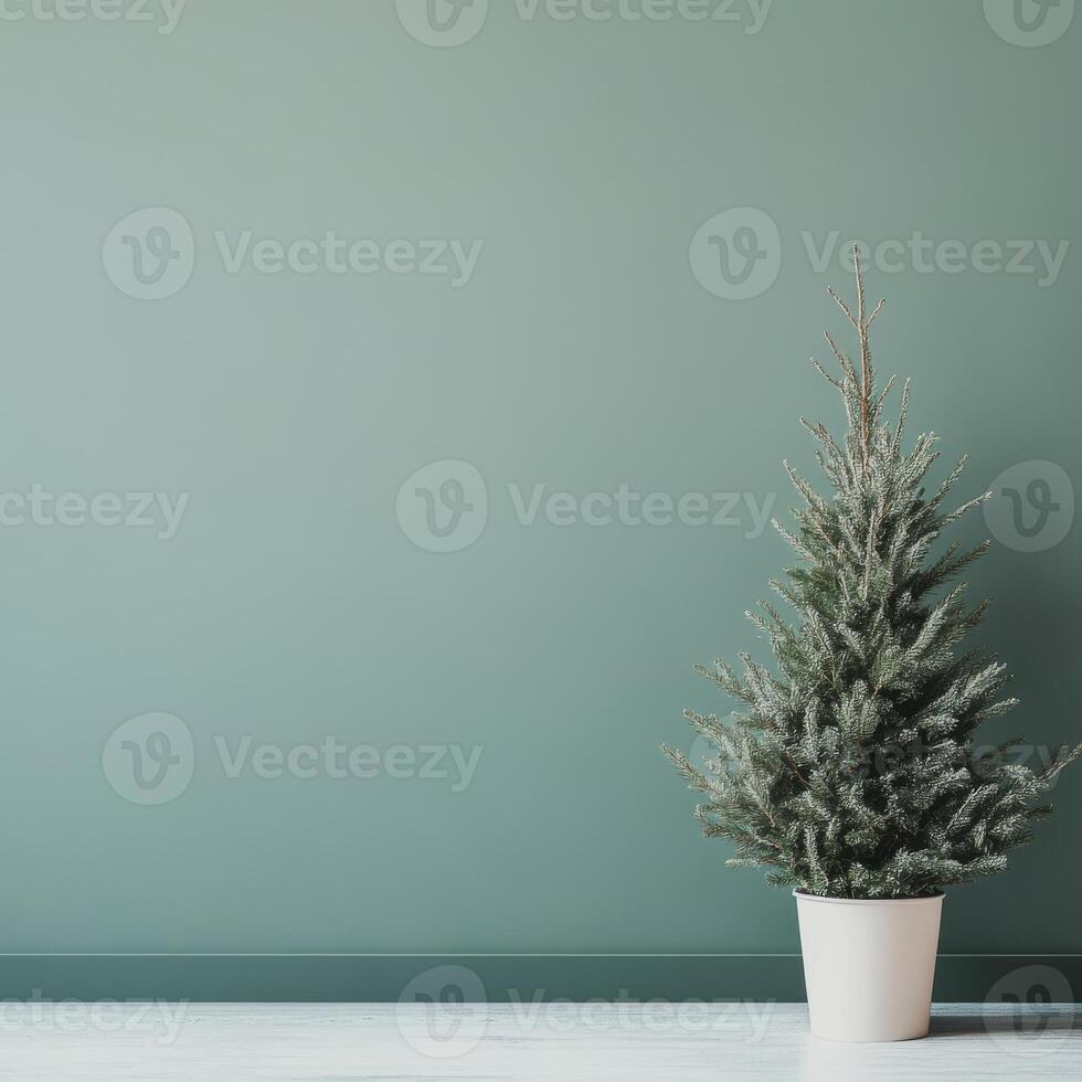 Minimalist Green Christmas Tree in White Pot Against a Soft Green Wall in a Modern Interior Setting photo