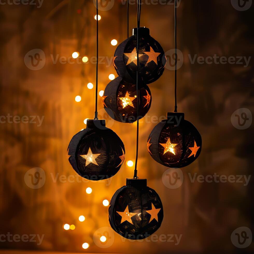 A string of lights with five black balls and stars hanging from a ceiling photo