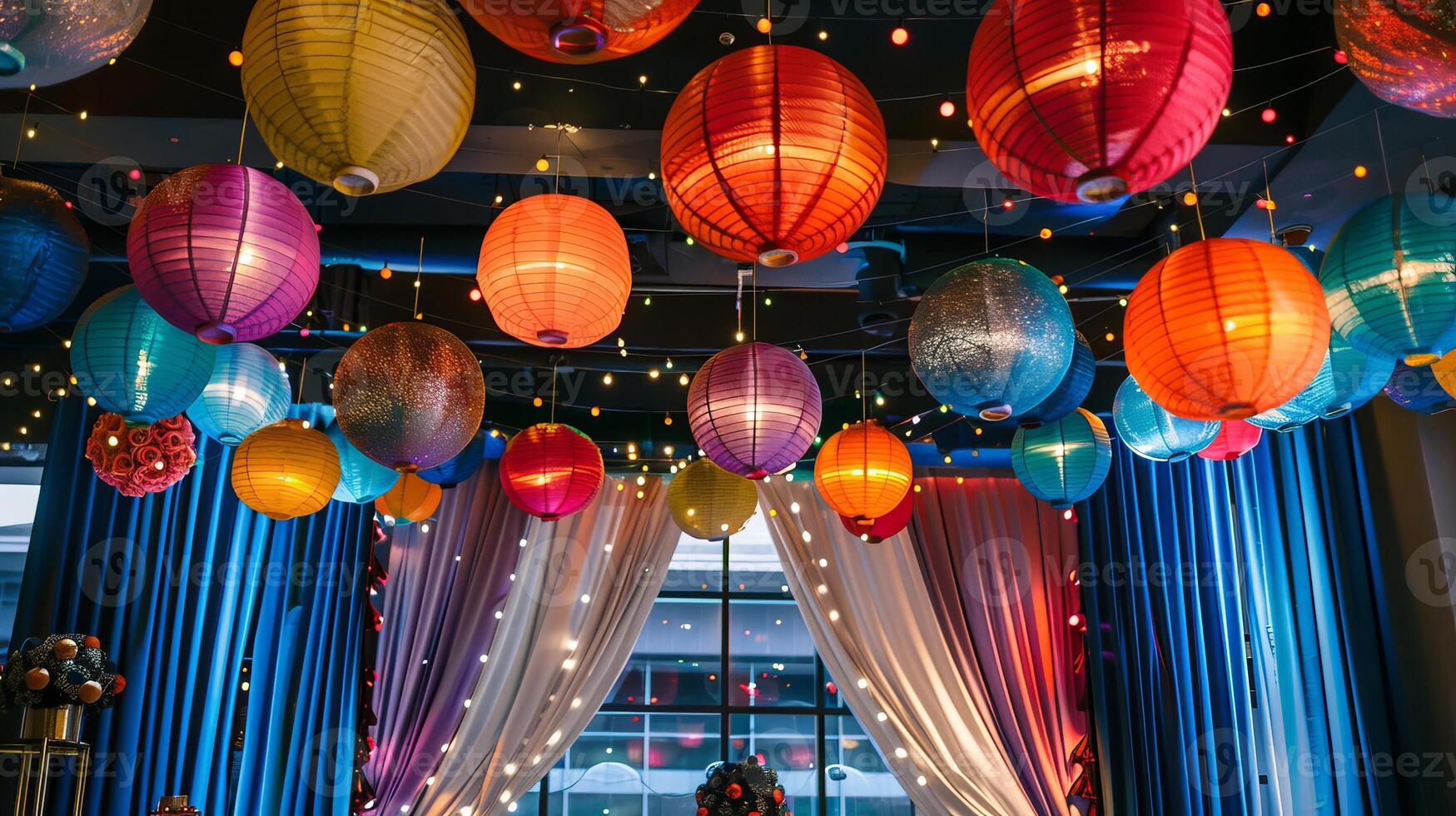 A room with many colorful lanterns hanging from the ceiling photo