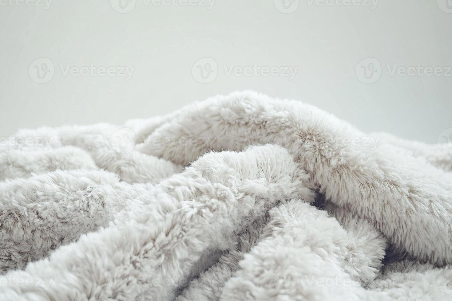 A fluffy white blanket with a fuzzy texture photo