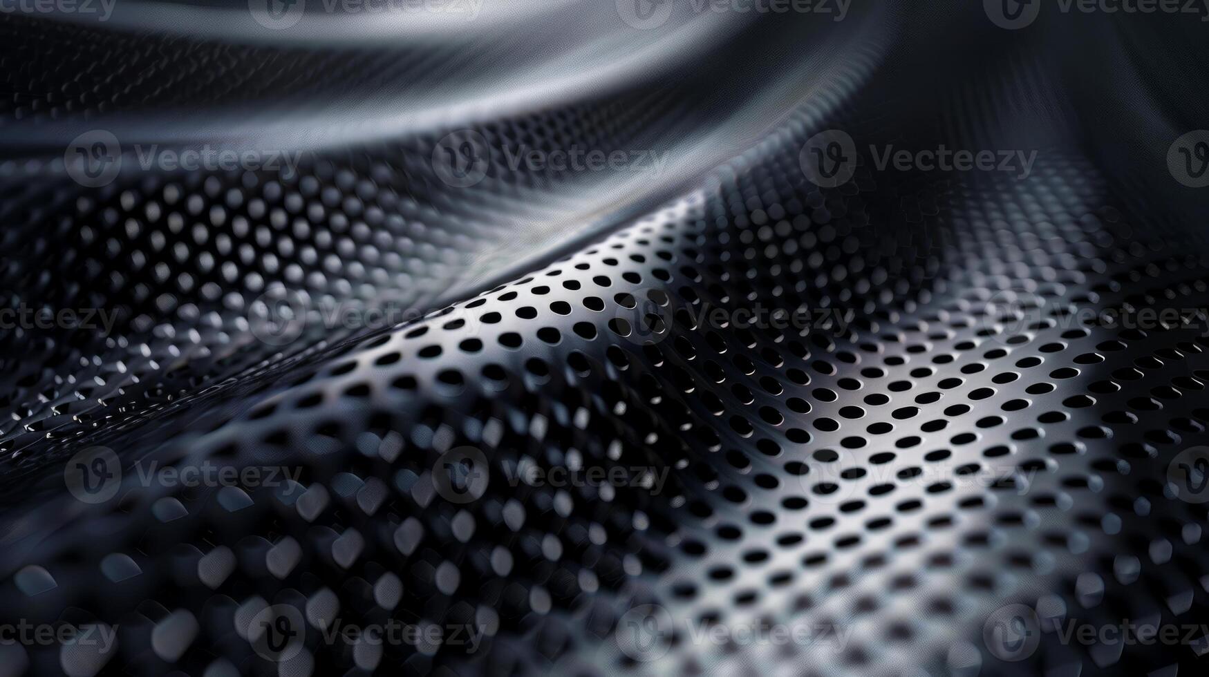 A close up of a black metal surface with a lot of holes photo