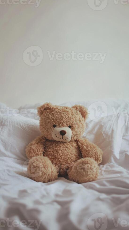 Cozy Teddy Bear on Soft White Bedding in Minimalist Bedroom Setting for Comfort and Warmth photo