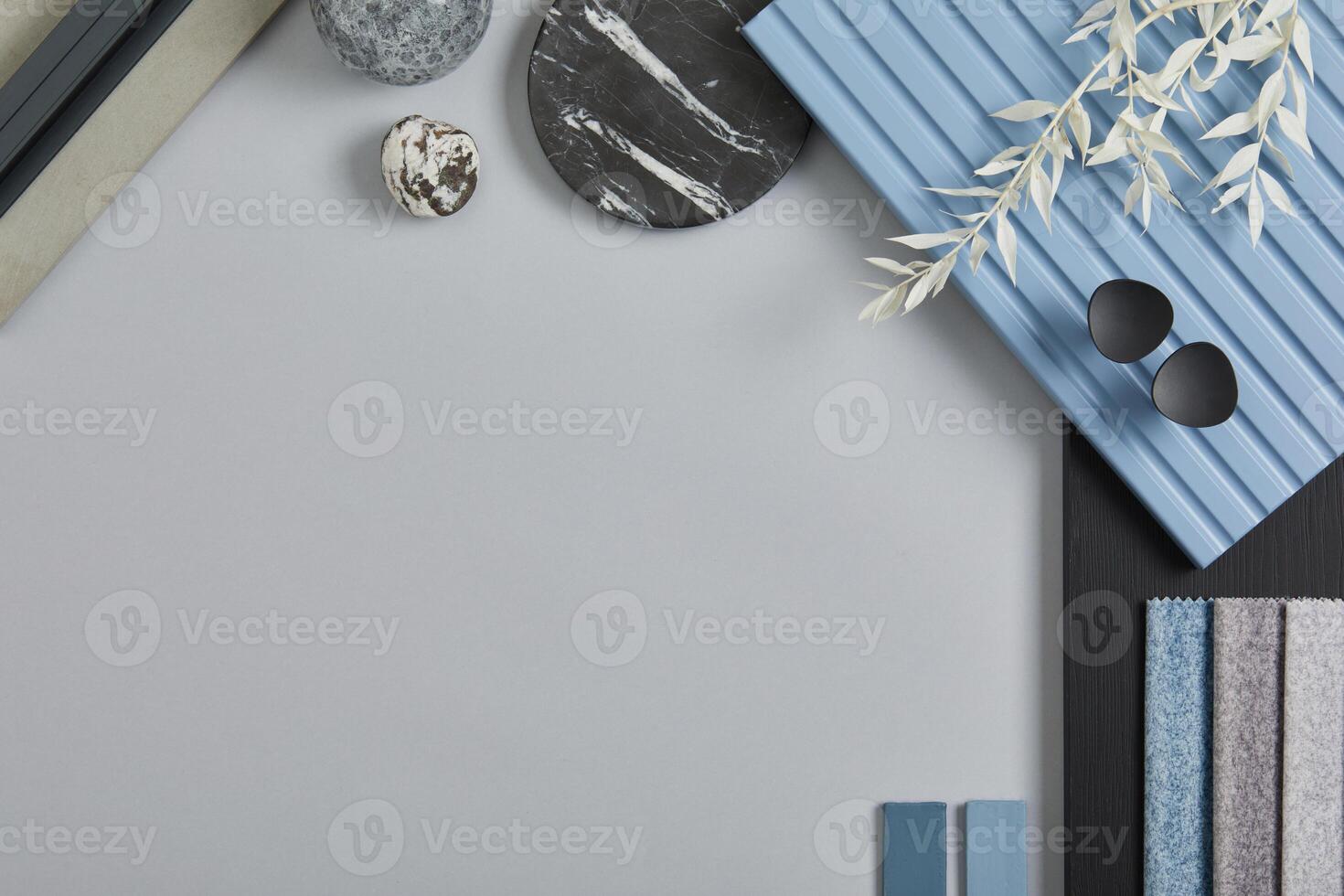 Flat lay composition of stylish architect moodboard with samples of textile, paint, blue wooden lamella panels and tiles. White, black, blue and light grey color palette. Copy space. Template. photo
