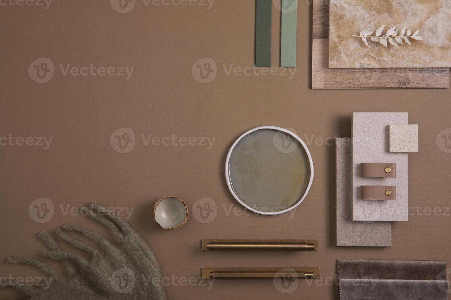 Creative flat lay composition of interior designer moodboard with textile and paint samples, panels and tiles. Beige, brown and green color palette. Copy space. Template. photo