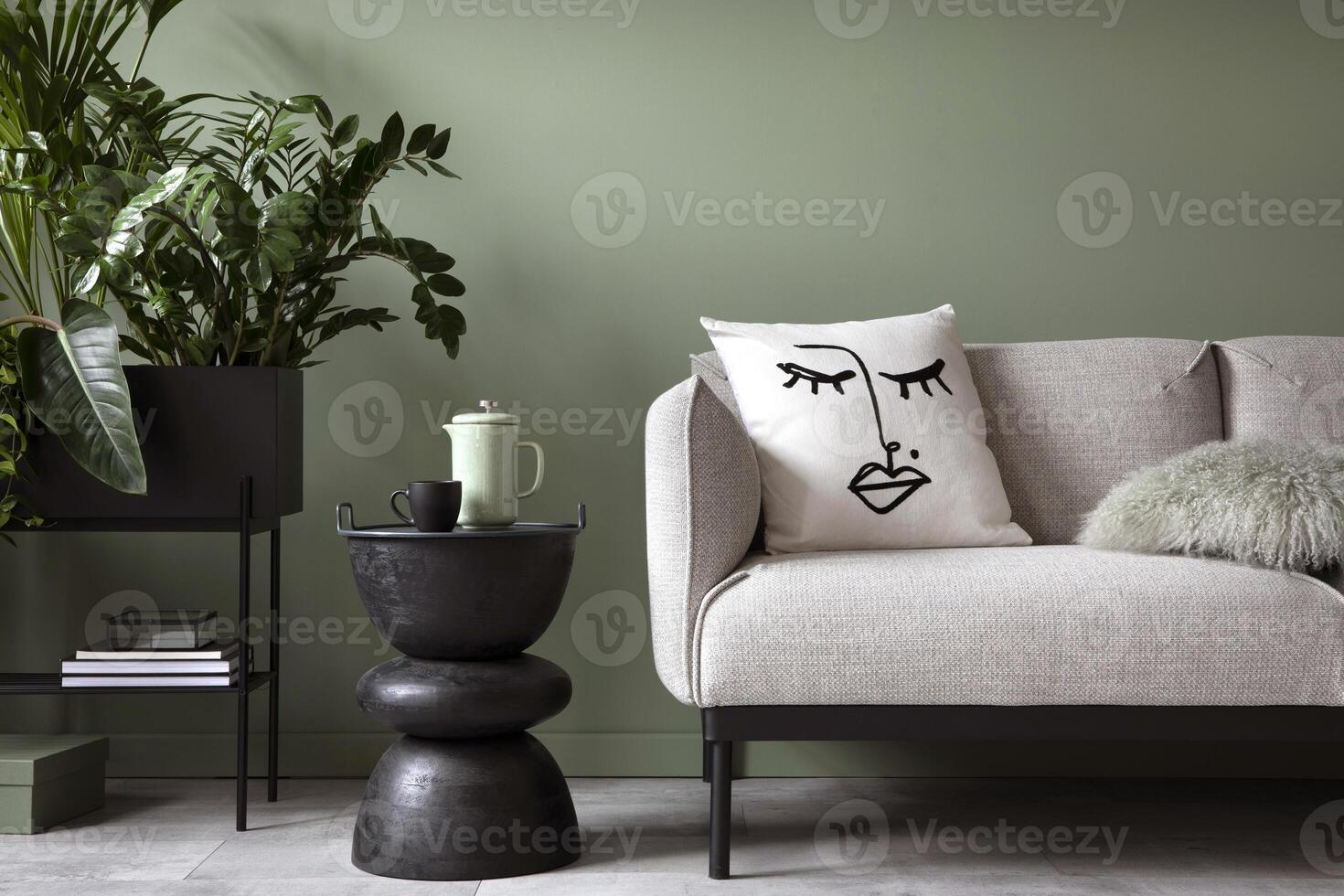 Stylish composition of living room interior. Modern sofa, design pillows, plants in metal pot and creative personal accessories. Eucalyptus green wall. Template. Copy space. photo
