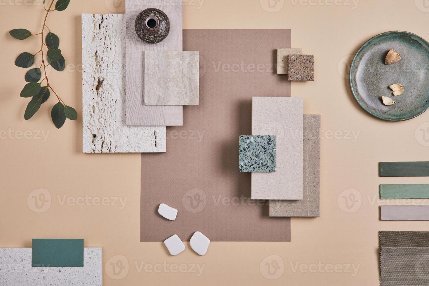 Creative flat lay composition of interior designer moodboard with textile and paint samples, panels and cement tiles. Beige, grey and green color palette. Copy space. Template. photo