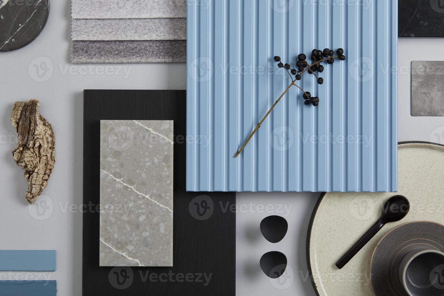 Flat lay composition of stylish architect moodboard with samples of textile, paint, blue wooden lamella panels and tiles. White, black, blue and light grey color palette. Copy space. Template. photo