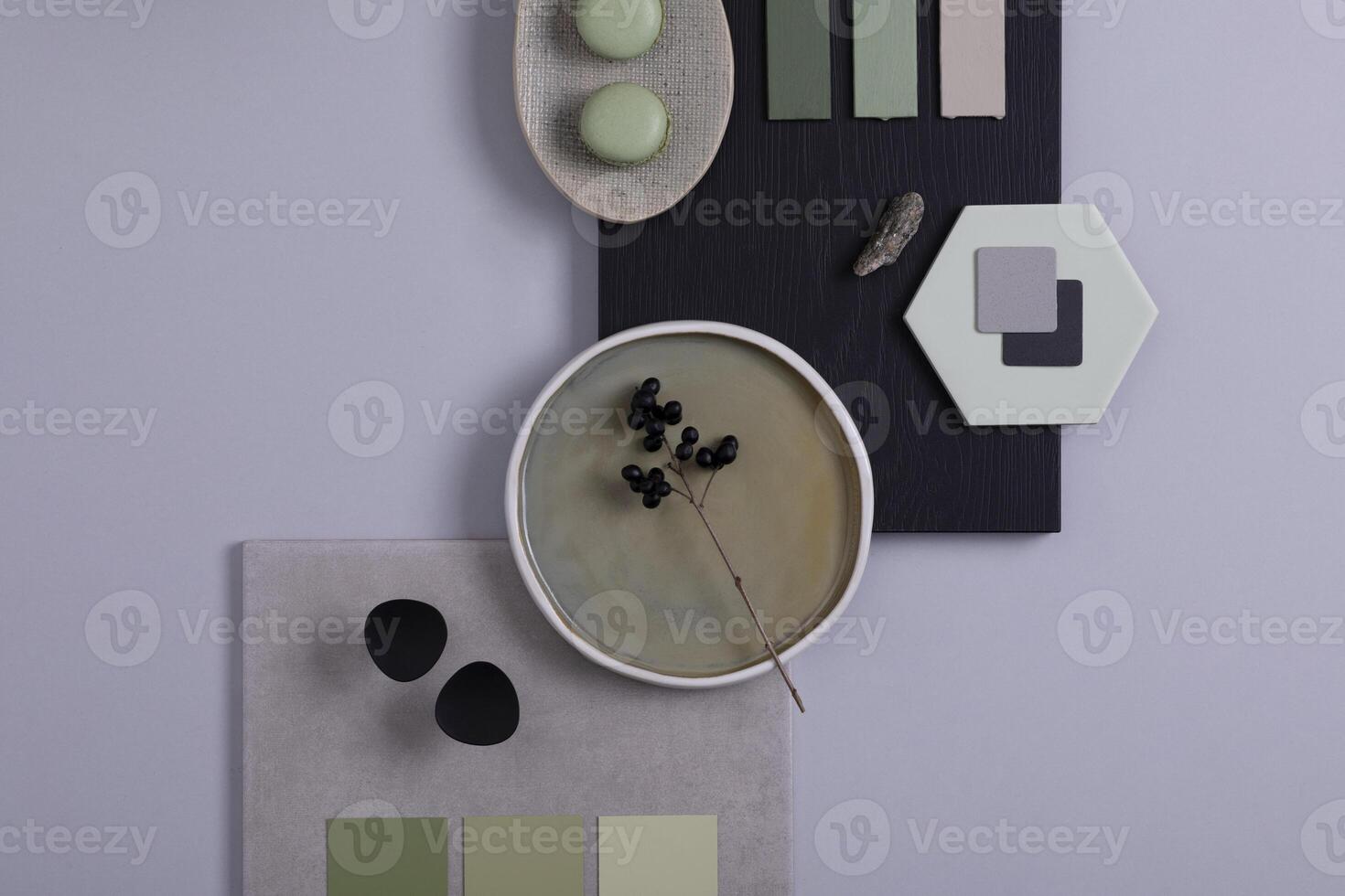 Stylish architect and interior designer moodboard. Flat lay composition in grey and green color palette with textile and paint samples, panels and tiles. Top view. Copy space. Template. photo