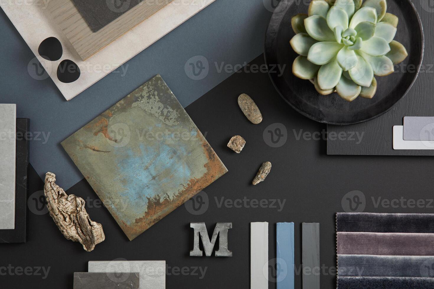Creative flat lay composition with textile and paint samples, panels and tiles. Stylish interior designer moodboard. Black, blue, beige and dark grey color palette. Copy space. Template. photo