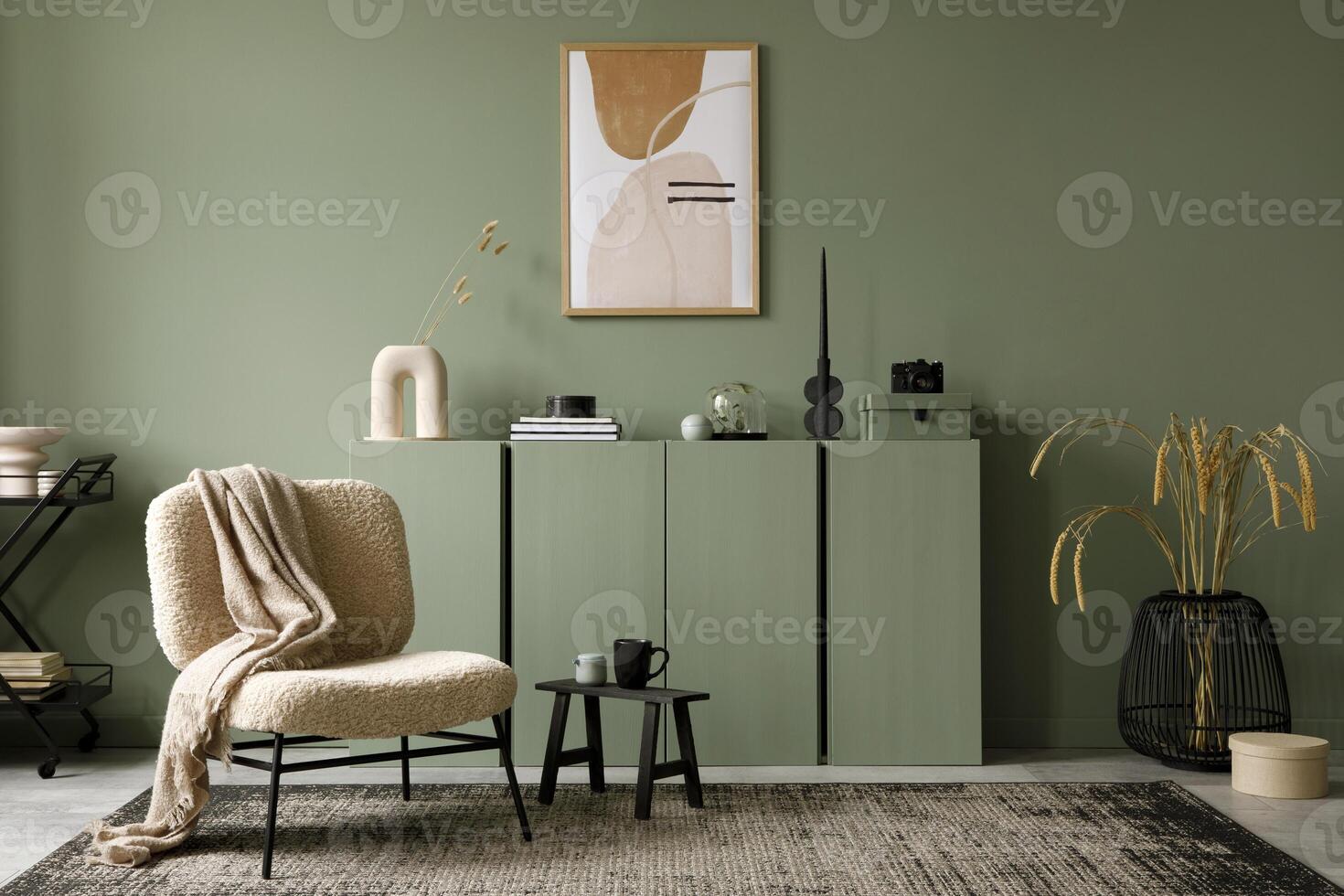 Stylish living room interior design with mock up poster frame, frotte armchair, wooden commode, side table, plants and creative home accessories. Eucalyptus wall. Home staging. Template. Copy space. photo