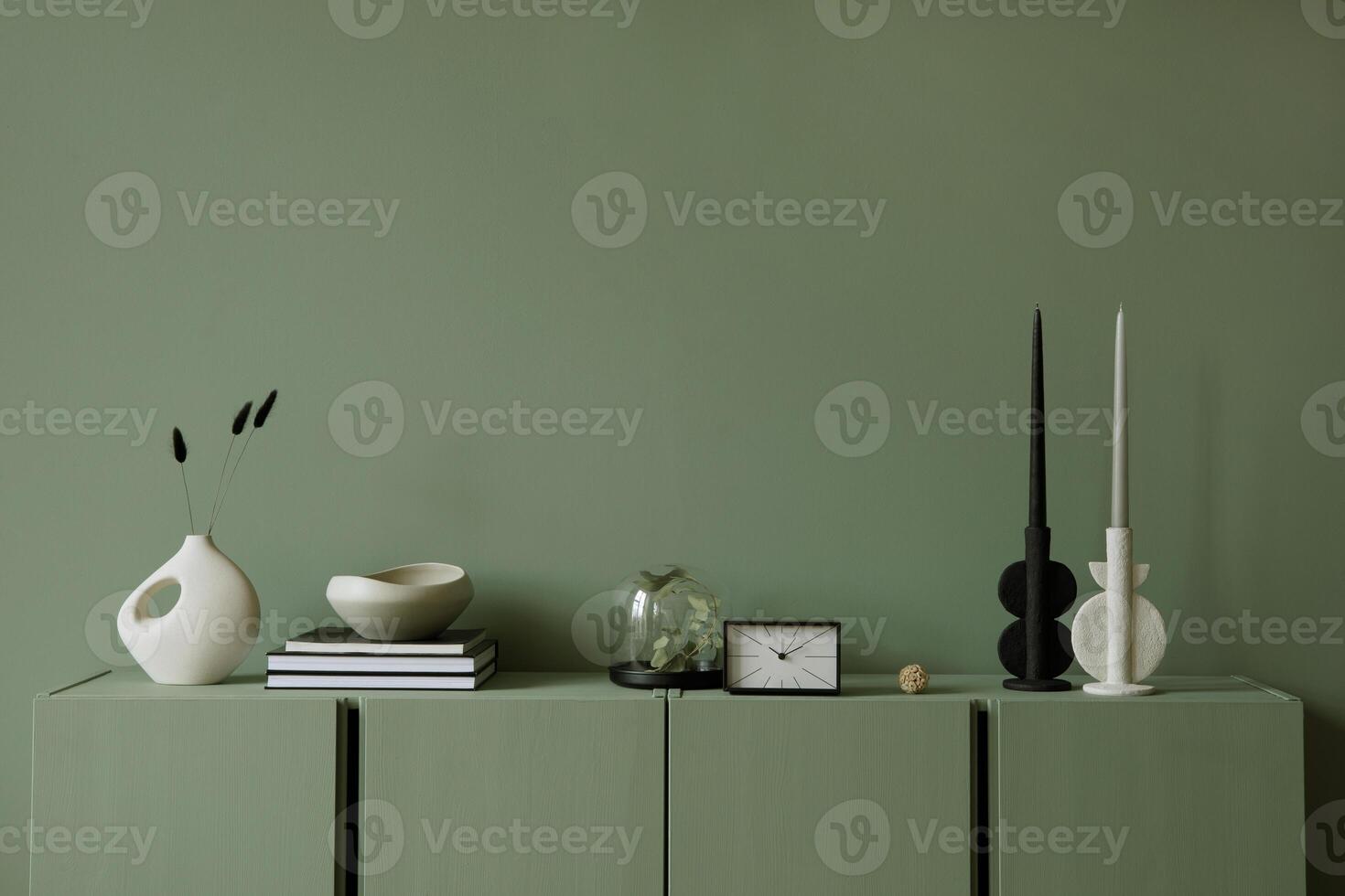 Modern living room interior composition with modern home decorations and personal accessories on the eucalyptus wooden commode. Sage green wall. Template. Copy space. photo