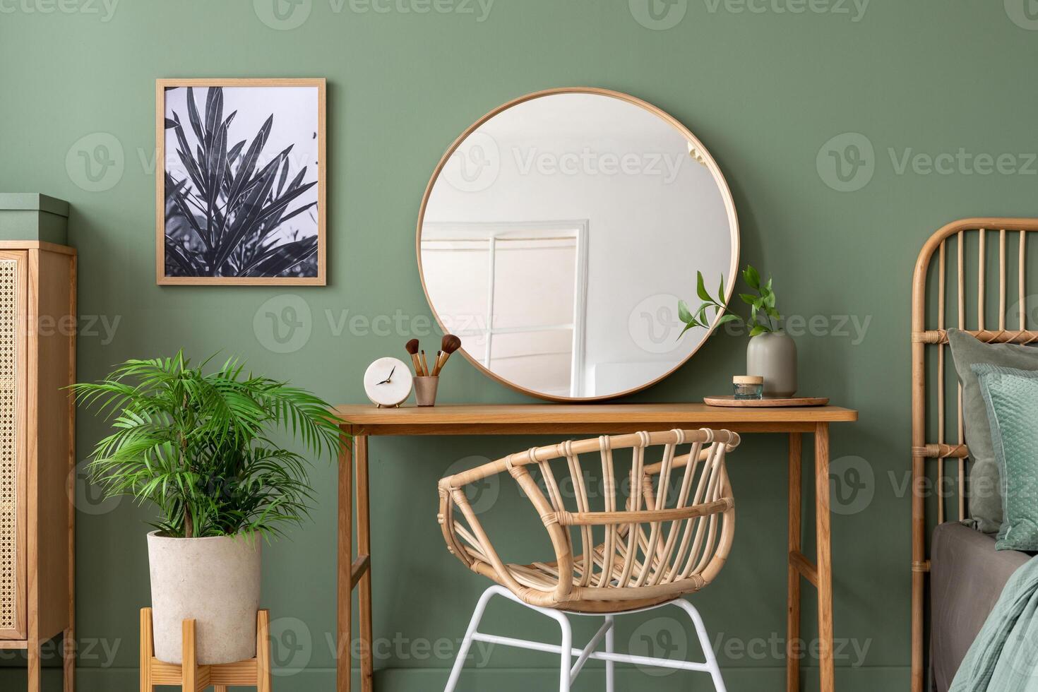 Elegant details of modern interior design with wooden sideboard, bed, mirror, painting and stylish personal accessories. Green wall. Mock up poster. Template.Elegant details of modern interior design photo