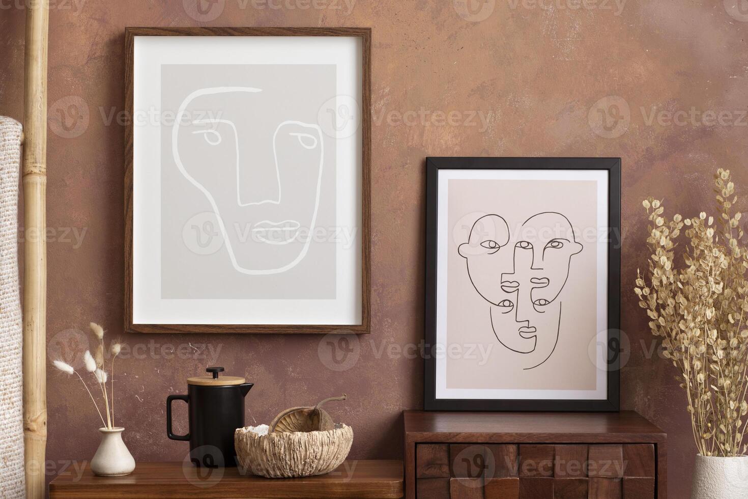 Warm and retro living room interior with mock up poster frame, stylish wooden coffee table, vase with dried flowers, black pitcher, ladder and personal accessories. Home decor. Template. photo