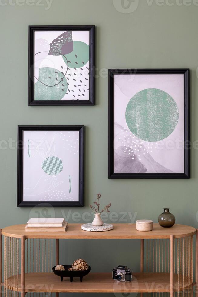 The stylish boho composition at living room interior with wooden console and elegant personal accessories. Mock up poster. Green wall. Home decor. Template. photo