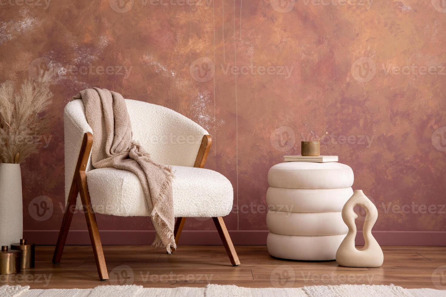 Minimalist composition of elegant and outstanding space with boucle armchair, modern pouf, design coffee table, lamp, vase with dried flowers and elegant accessories. Home decor. Template. photo
