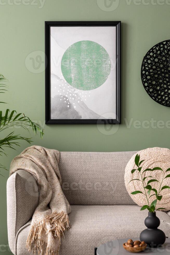 The stylish composition at living room interior with mock up, design gray sofa, coffee table, dark lamp and elegant personal accessories. Beige pillow and plaid. Mock up poster. Template. photo
