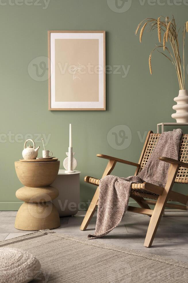 Stylish living room interior design with mock up poster frames, rattan armchair, coffe table, beige carpet and creative home accessories. Sage green wall. Template. photo