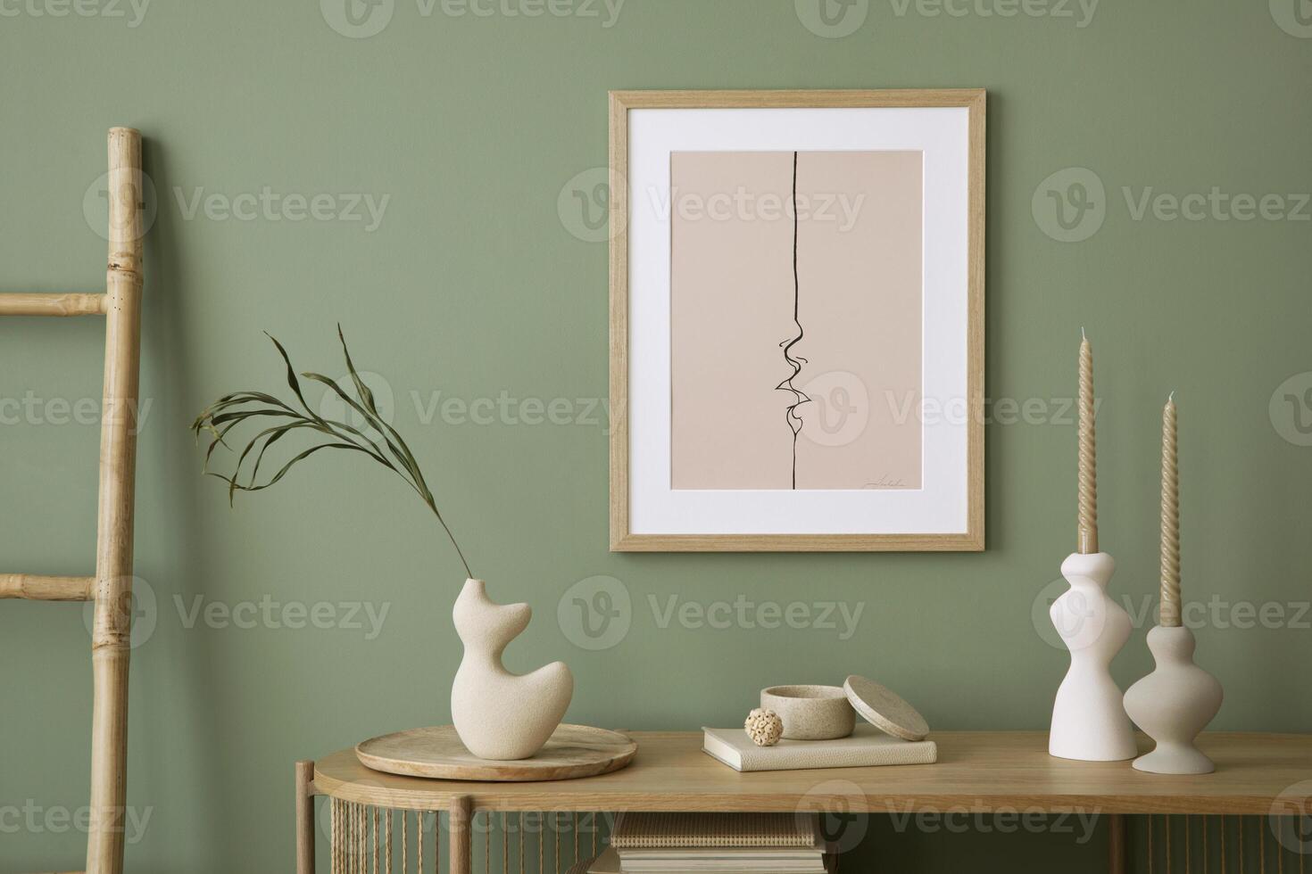 Stylish living room interior design with mock up poster frames, wooden chest of drawers, beige vase and creative home accessories. Sage green wall. Template. photo