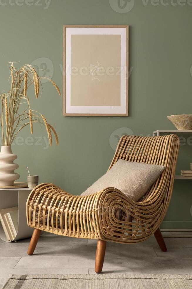Stylish living room interior design with mock up poster frames, wicker armchair , coffe table, beige carpet and creative home accessories. Sage green wall. Template. photo