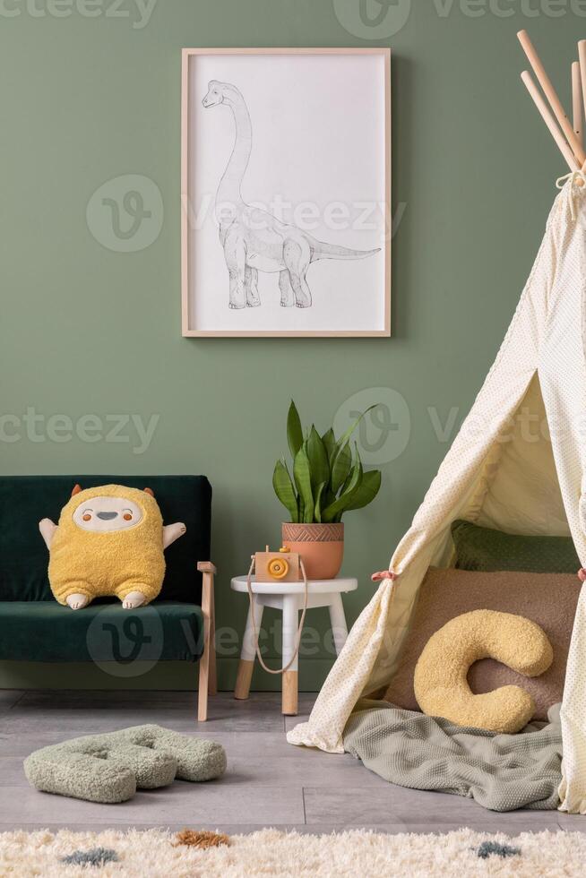 Stylish composition of cozy child room interior design with green wall with poster and green sofa. Stool with plant and accessories. Mock up. Green sofa, posters, plush pillow and bright carpet. photo