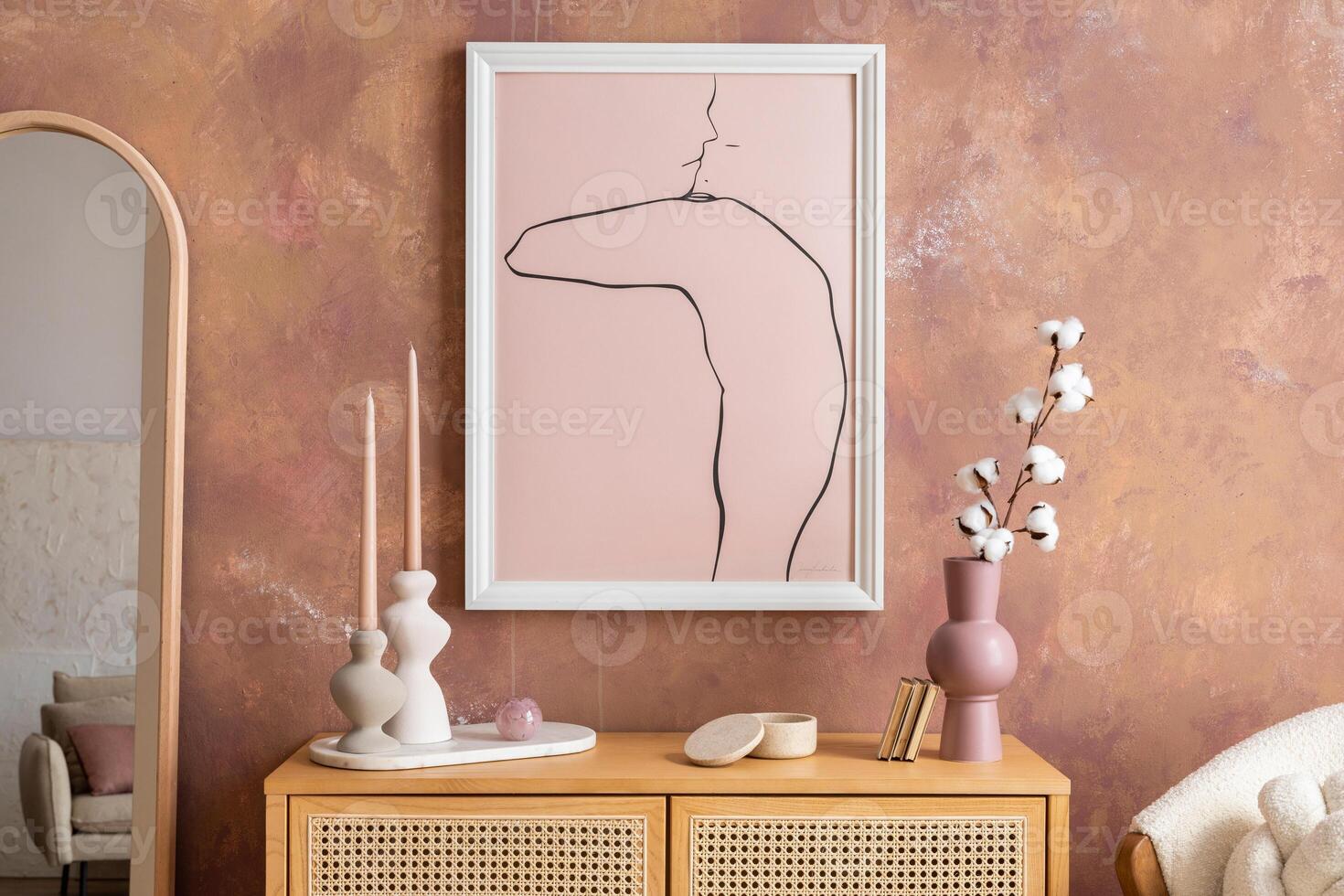 Creative composition vintage living room with rattan chest of drawers, armachair with plaid, candlestick with candle, mirror and minimalistic poster. Stylish accessories. Mock up. Template. photo