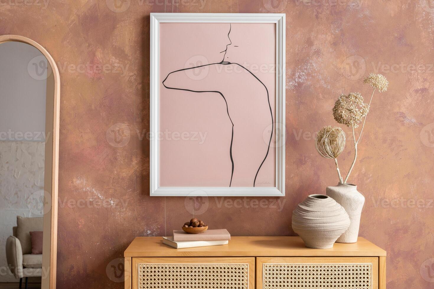 Creative composition vintage living room with rattan chest of drawers, armachair with plaid, candlestick with candle, mirror and minimalistic poster. Stylish accessories. Mock up. Template. photo