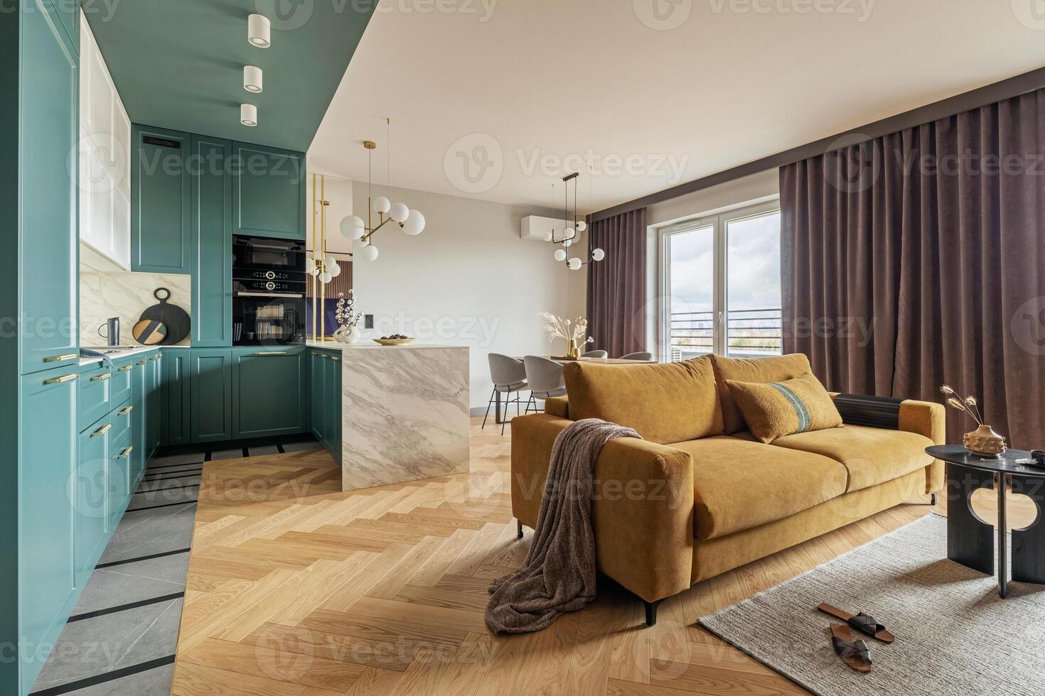 Creative and modern vintage open space interior design with yellow sofa and turquoise kitchen with island. Grey carpet on the herringbone parquet with coffee table, curtain in windows. Template. photo