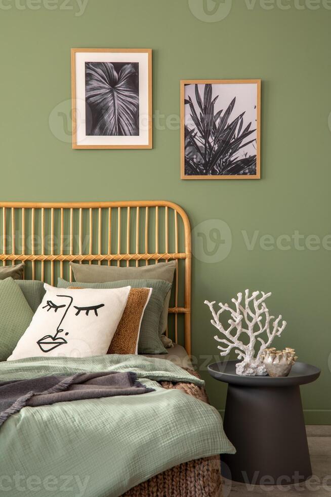 Elegant bedroom interior design with mock up poster frames, bamboo bed, modern bedclothes, side table and stylish accessories. Eucalyptus wall. Template. Copy space. photo