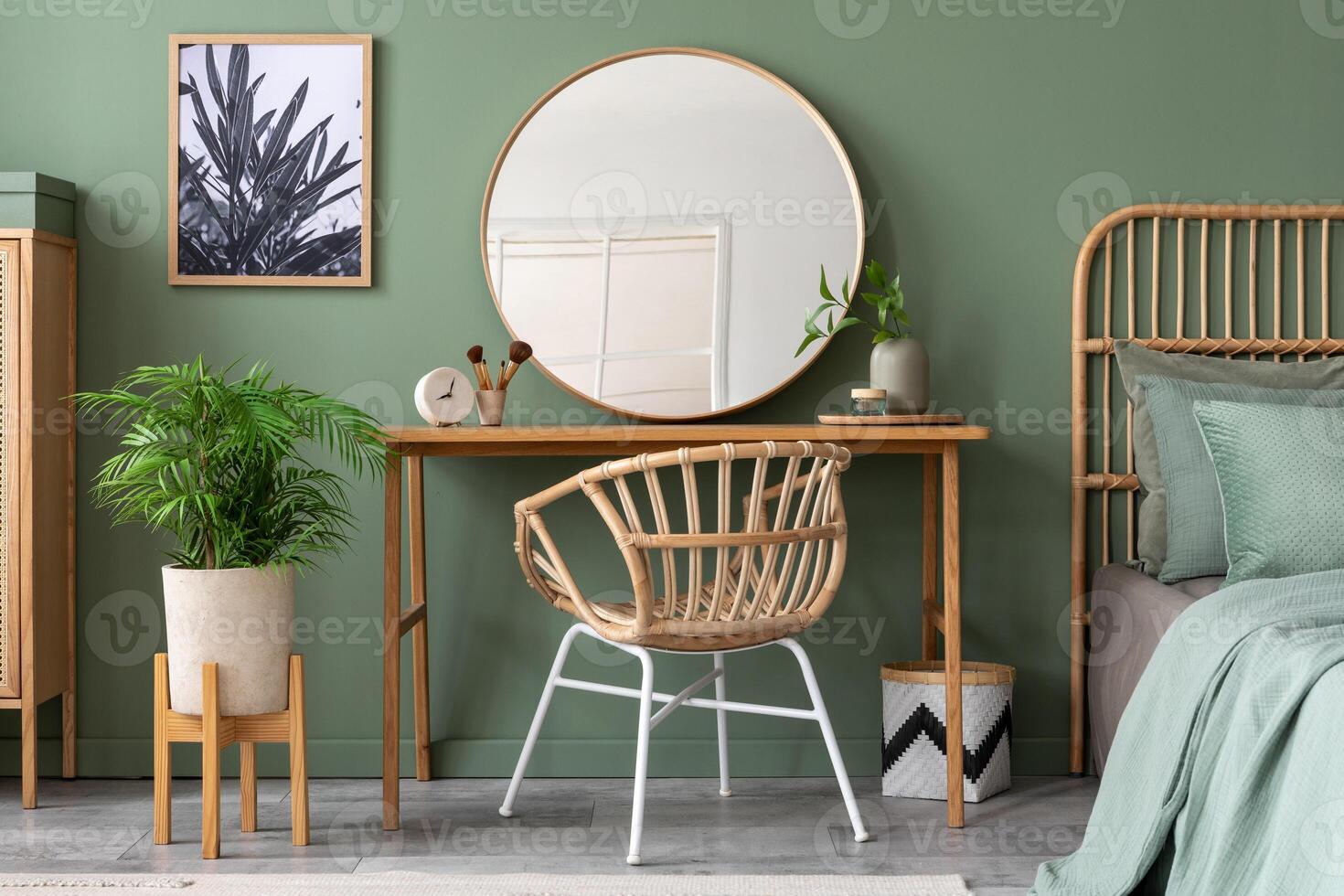 Elegant details of modern interior design with wooden sideboard, bed, mirror, painting and stylish personal accessories. Green wall. Mock up poster. Template. photo