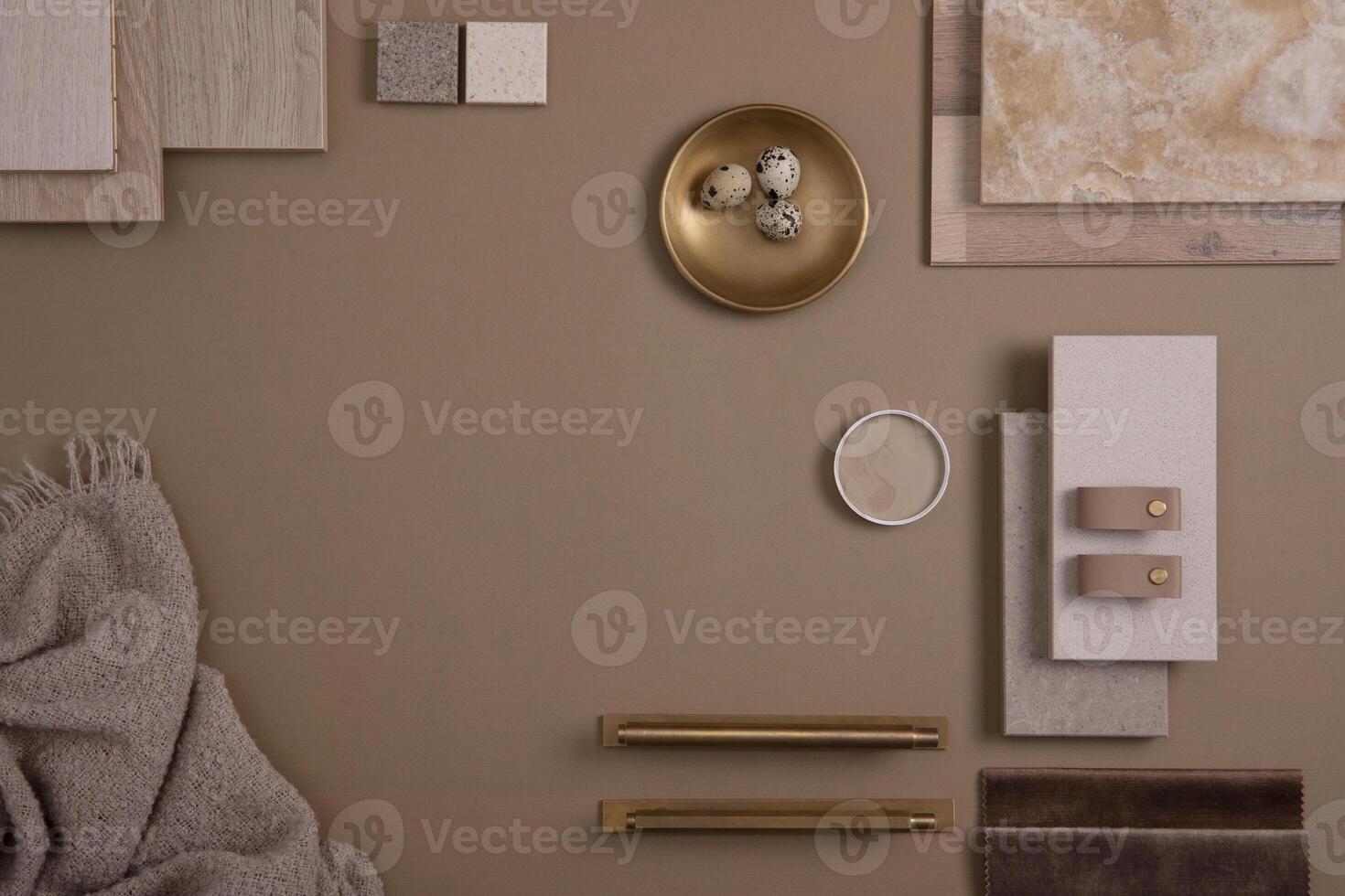 Creative flat lay composition with textile and paint samples, panels and tiles. Stylish interior designer moodboard. Golden and dark beige color palette. Copy space. Template. photo