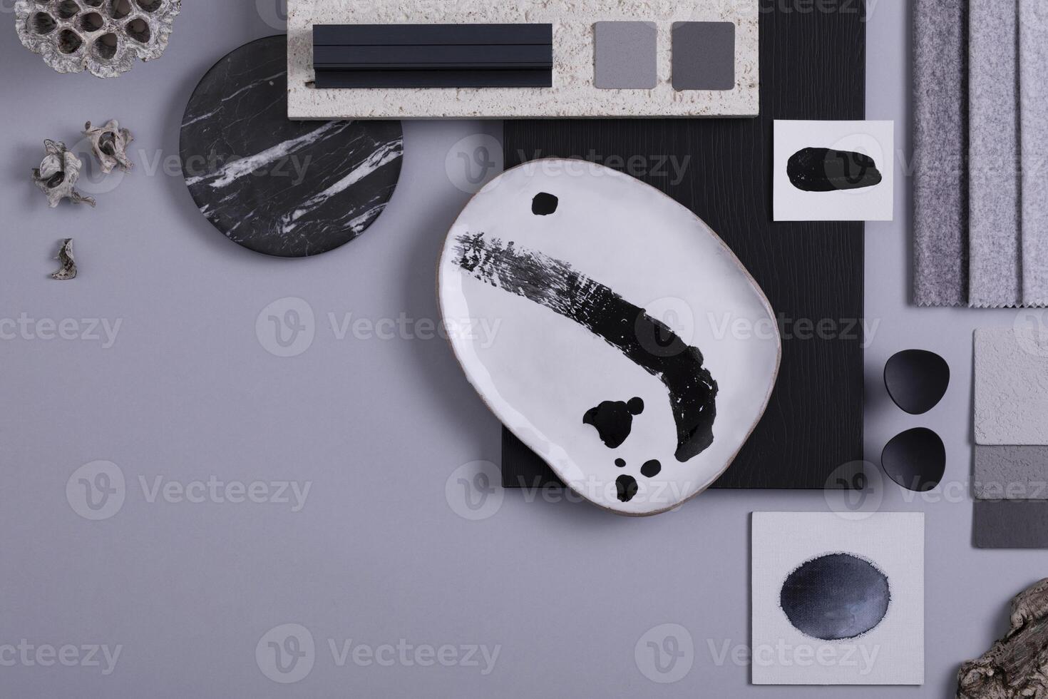 Creative flat lay composition in grey and black color palette with textile and paint samples, panels and tiles. Architect and interior designer moodboard. Top view. Copy space. Template. photo