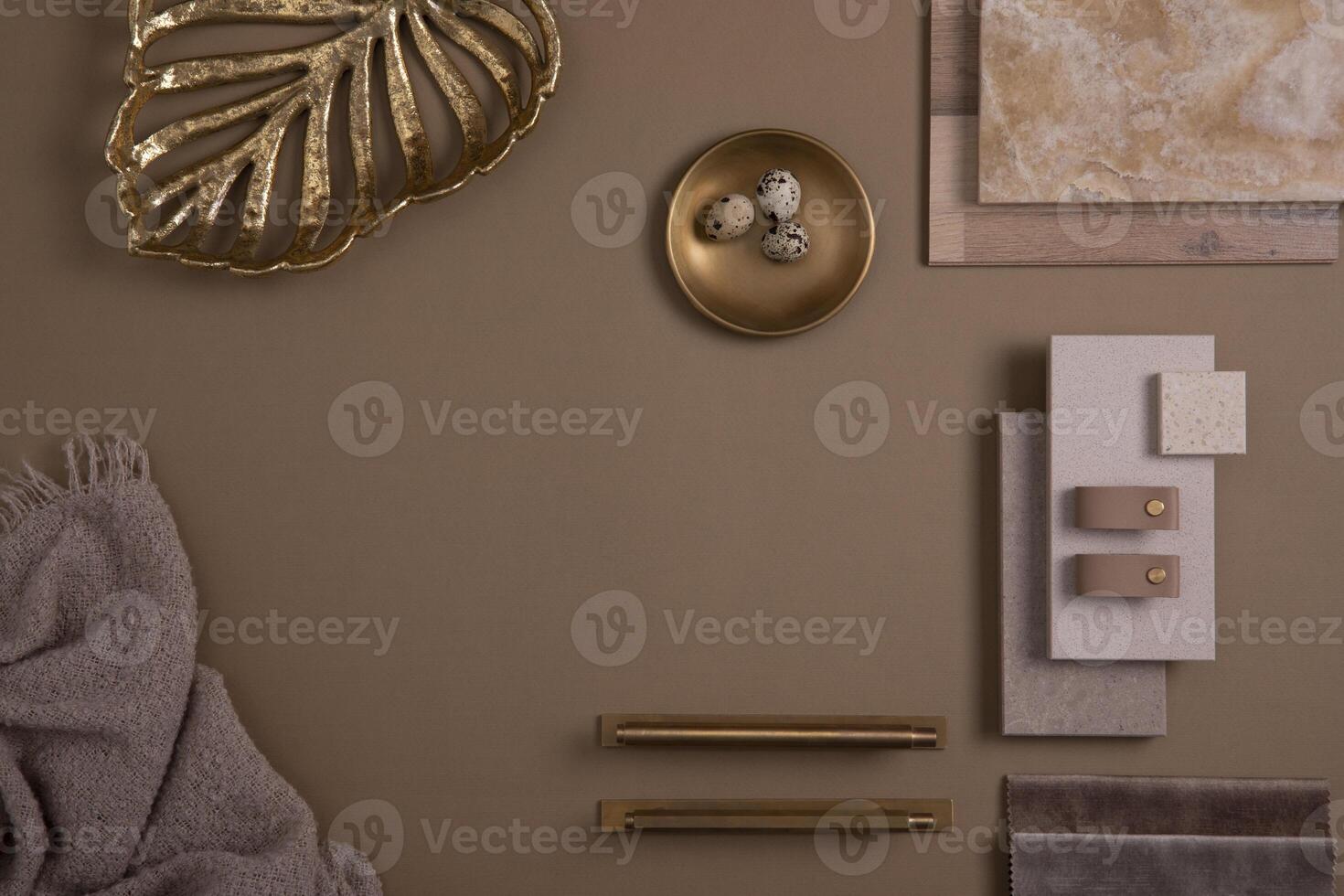 Creative flat lay composition with textile and paint samples, panels and tiles. Stylish interior designer moodboard. Golden and dark beige color palette. Copy space. Template. photo