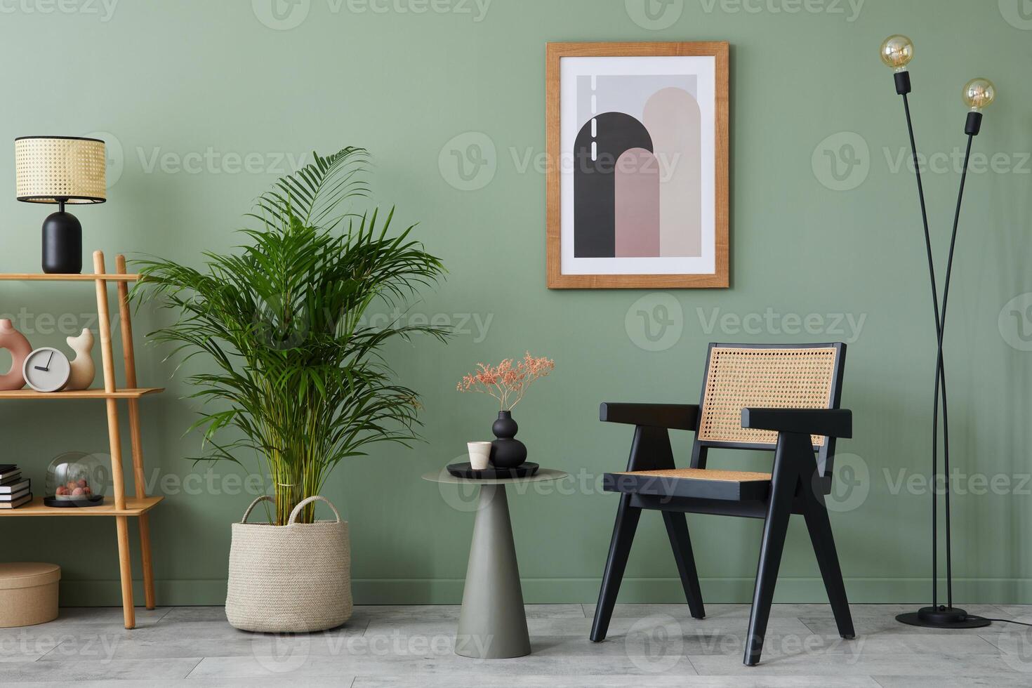 Stylish living room interior design with mock up poster frame, wooden armchair, shelf, side table, plants and creative home accessories. Eucalyptus wall. Home staging. Template. Copy space. photo