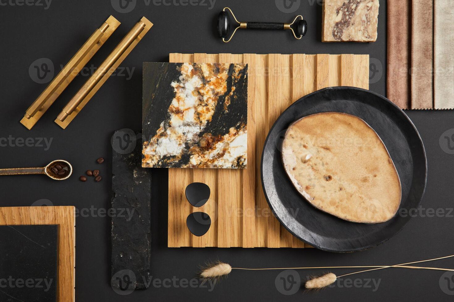 Stylish flat lay comosition of creative architect moodboard with samples of textile, paint, wooden lamella panel and marble tile. Golden, black and beige color palette. Copy space. Template. photo