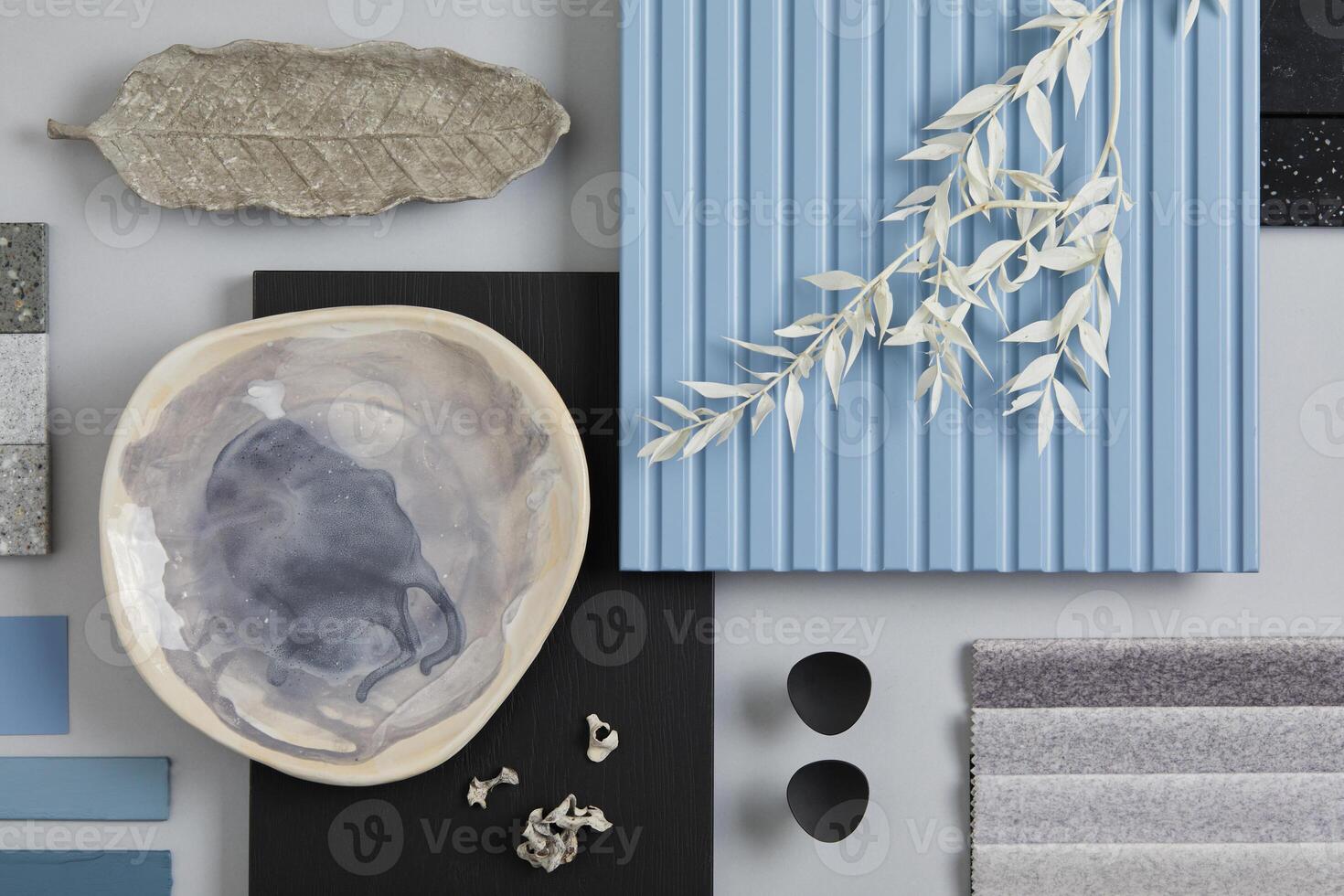 Flat lay composition of stylish architect moodboard with samples of textile, paint, blue wooden lamella panels and tiles. White, black, blue and light grey color palette. Copy space. Template. photo