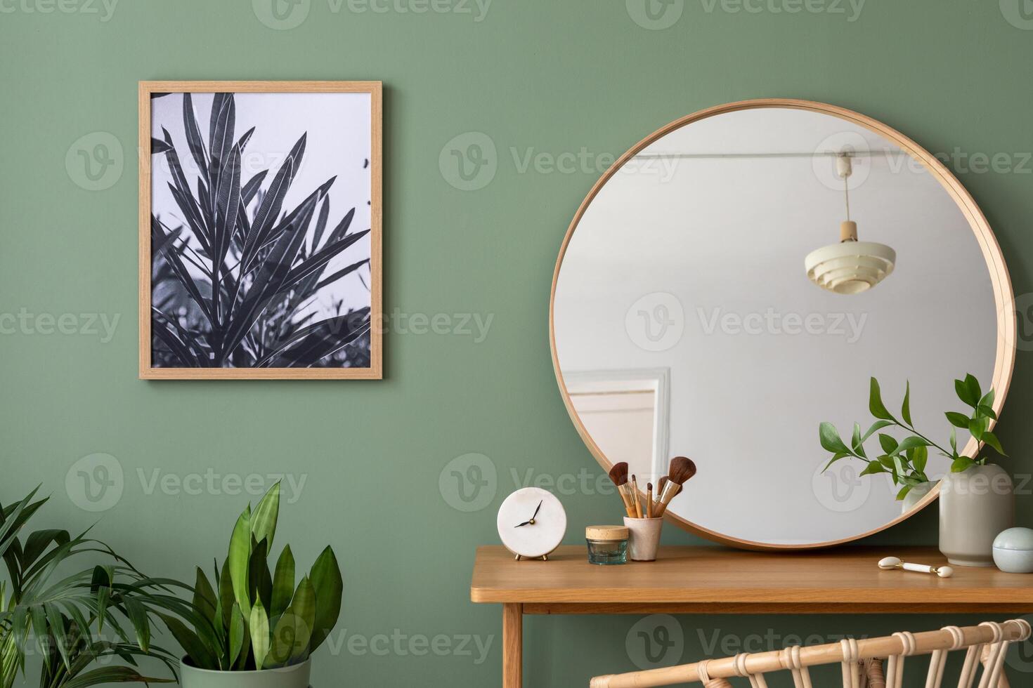 Elegant details of modern interior design with poster, round mirror, plant and stylish personal accessories. Wooden vanity table. Mock up poster. Template. photo