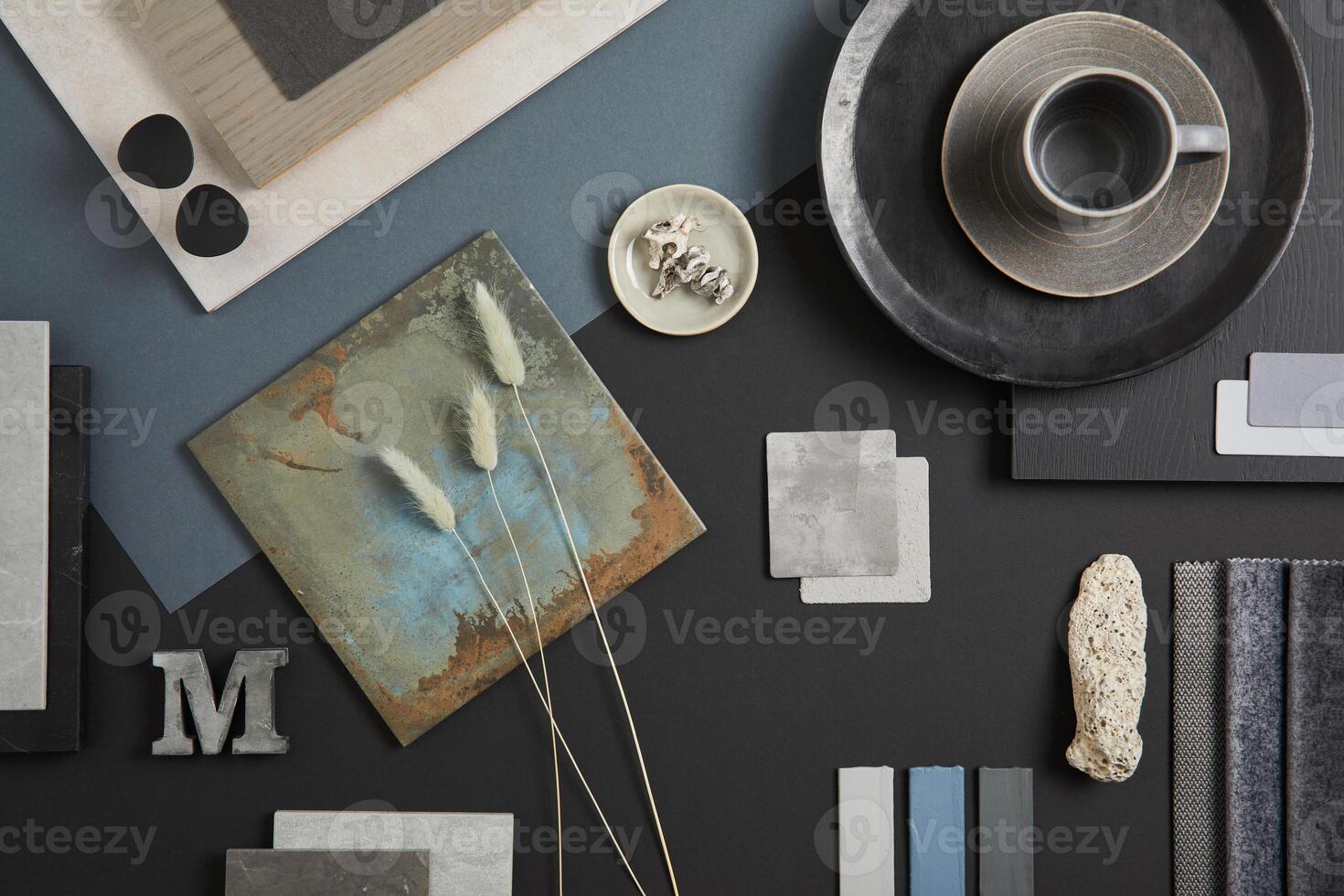 Creative flat lay composition with textile and paint samples, panels and tiles. Stylish interior designer moodboard. Black, blue, beige and dark grey color palette. Copy space. Template. photo