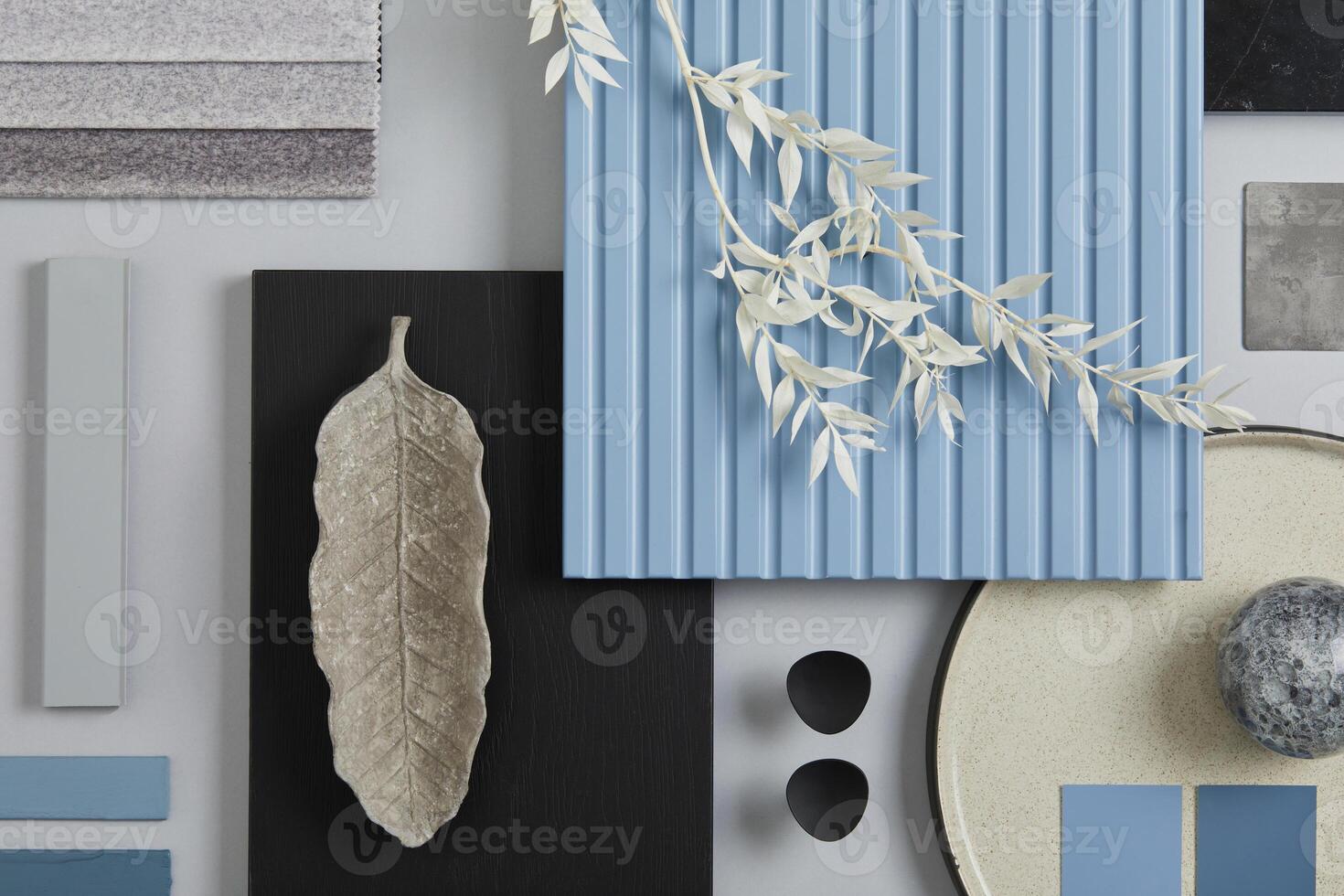 Flat lay composition of stylish architect moodboard with samples of textile, paint, blue wooden lamella panels and tiles. White, black, blue and light grey color palette. Copy space. Template. photo