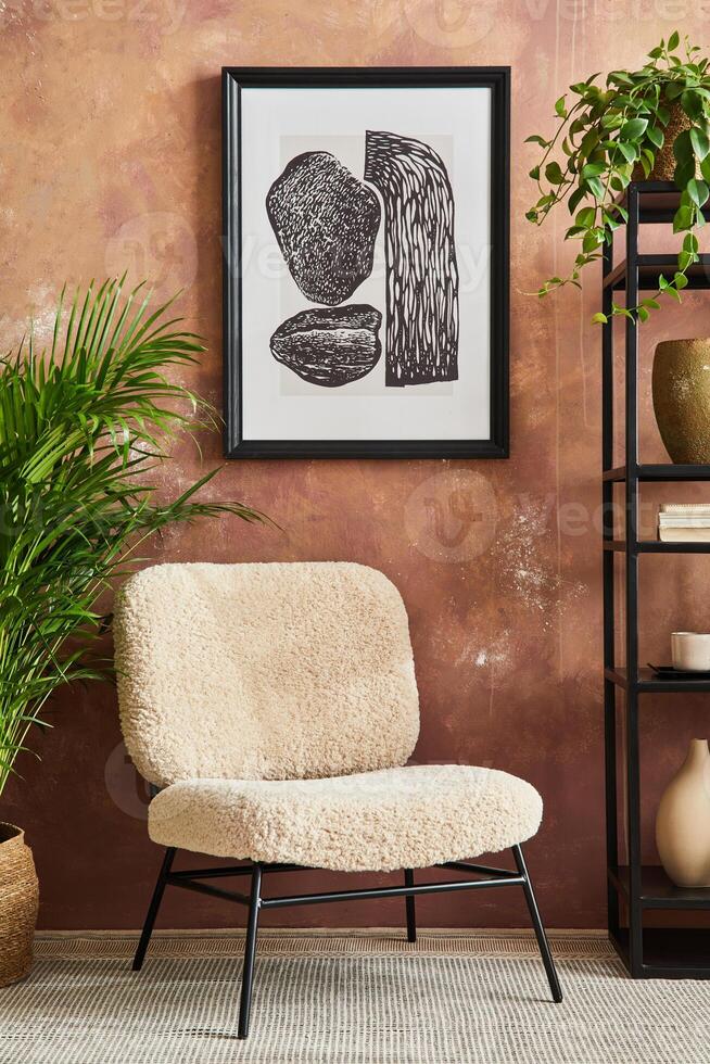 Stylish living room interior design with mock up poster frame frotte armchair, black metal shelf, side table, plants and creative home accessories. Home staging. Template. Copy space. photo