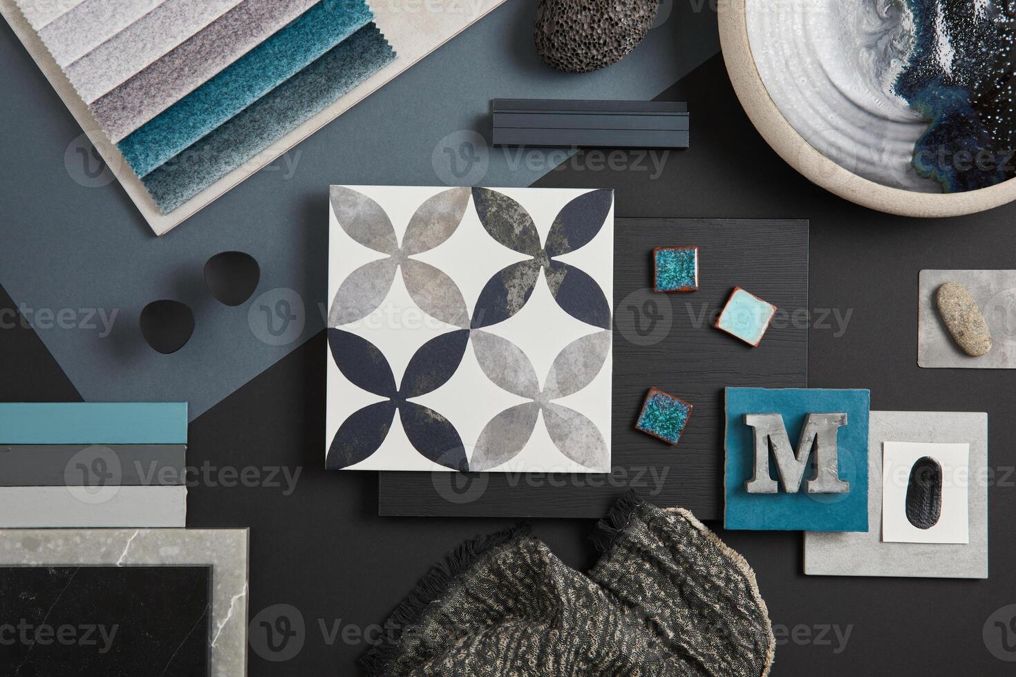Elegant flat lay composition of interior designer moodboard with textile and paint samples, panels and tiles. Black, blue, beige and dark grey color palette. Copy space. Template. photo