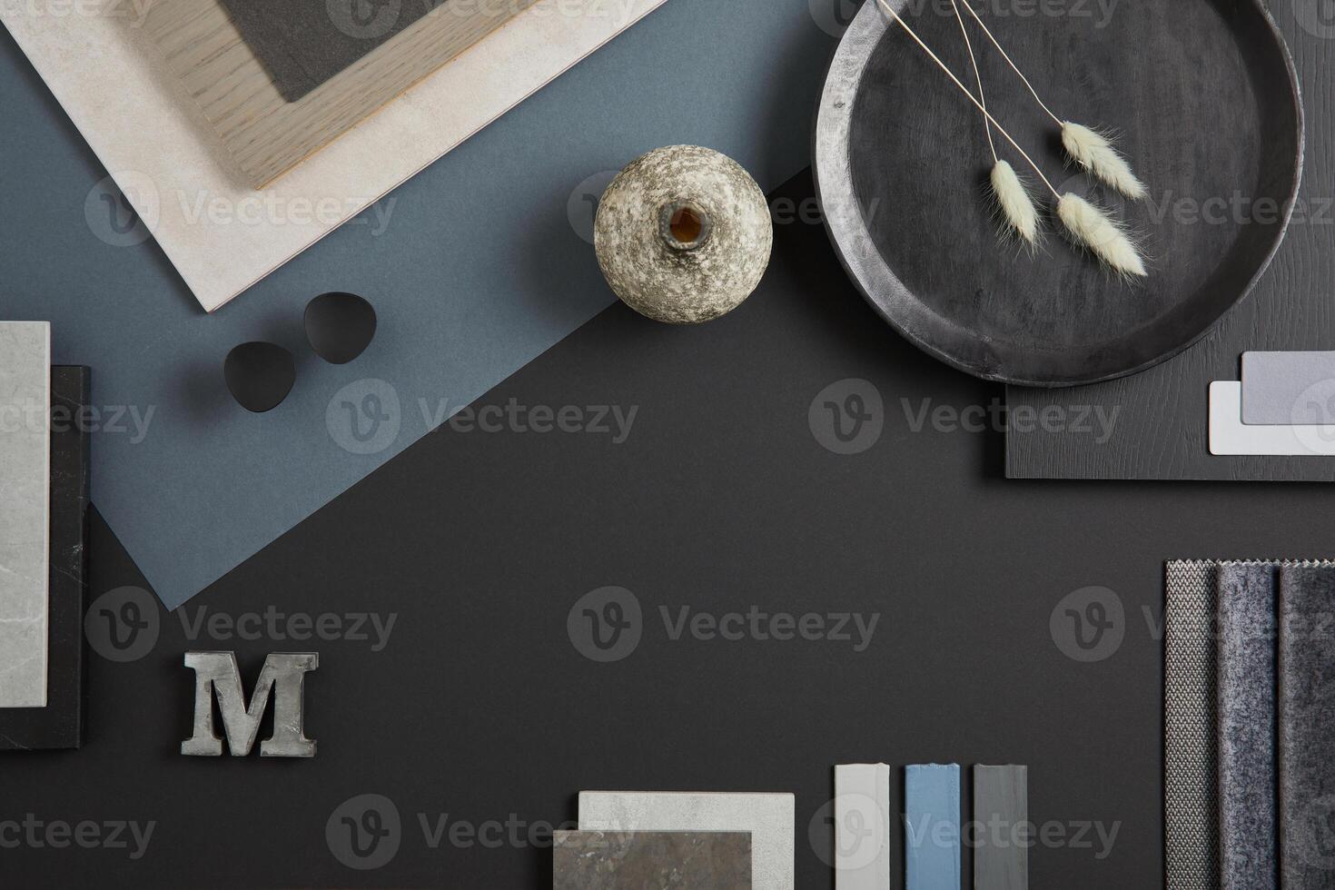 Elegant flat lay composition of interior designer moodboard with textile and paint samples, panels and tiles. Black, blue, beige and dark grey color palette. Copy space. Template. photo