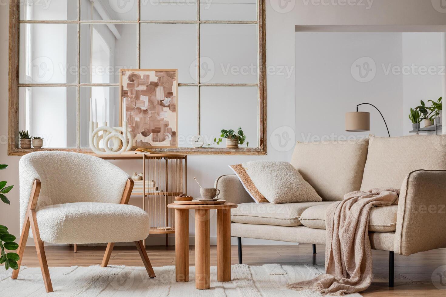 Stylish compositon of neutral living room interior with frotte armchair, sofa, creative painting, wooden commode, side table and elegant home accessories. Template. Copy space. photo