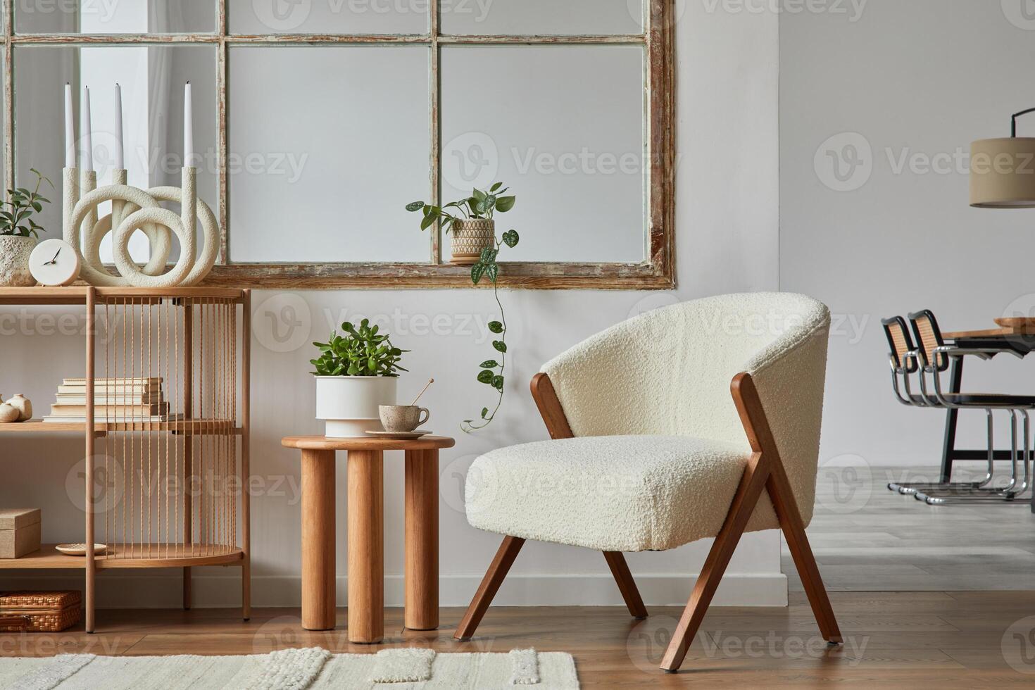Stylish compositon of modern living room interior with frotte armchair, wooden commode, side table and elegant home accessories. Home staging. Template. Copy space. Dining room in the background photo