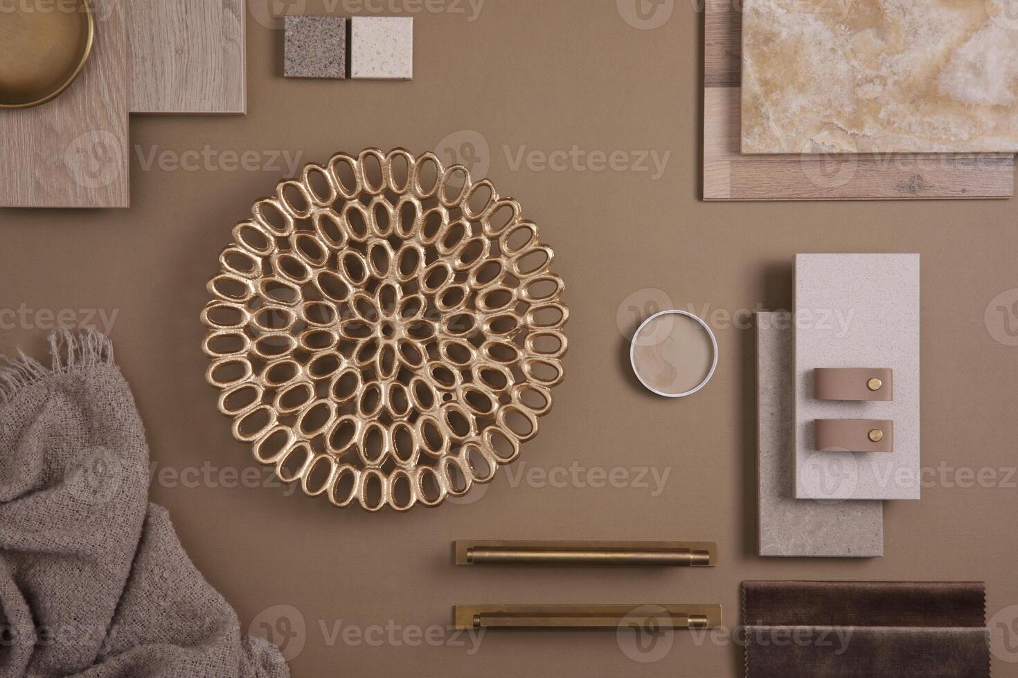 Creative flat lay composition with textile and paint samples, panels and tiles. Stylish interior designer moodboard. Golden and dark beige color palette. Copy space. Template. photo