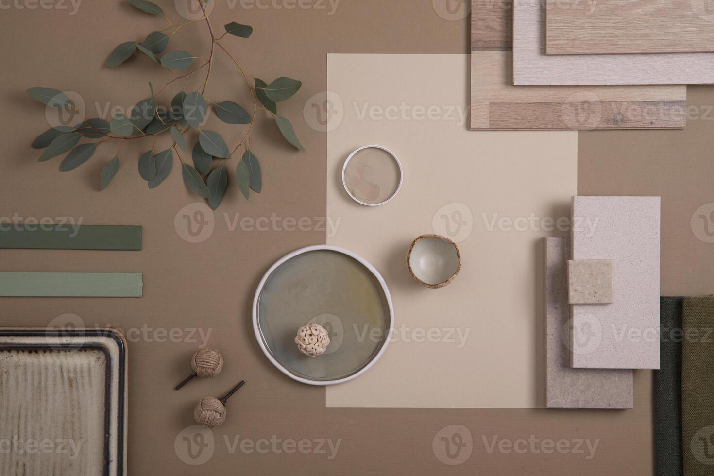 Creative flat lay composition of interior designer moodboard with textile and paint samples, panels and tiles. Beige, brown and green color palette. Copy space. Template. photo