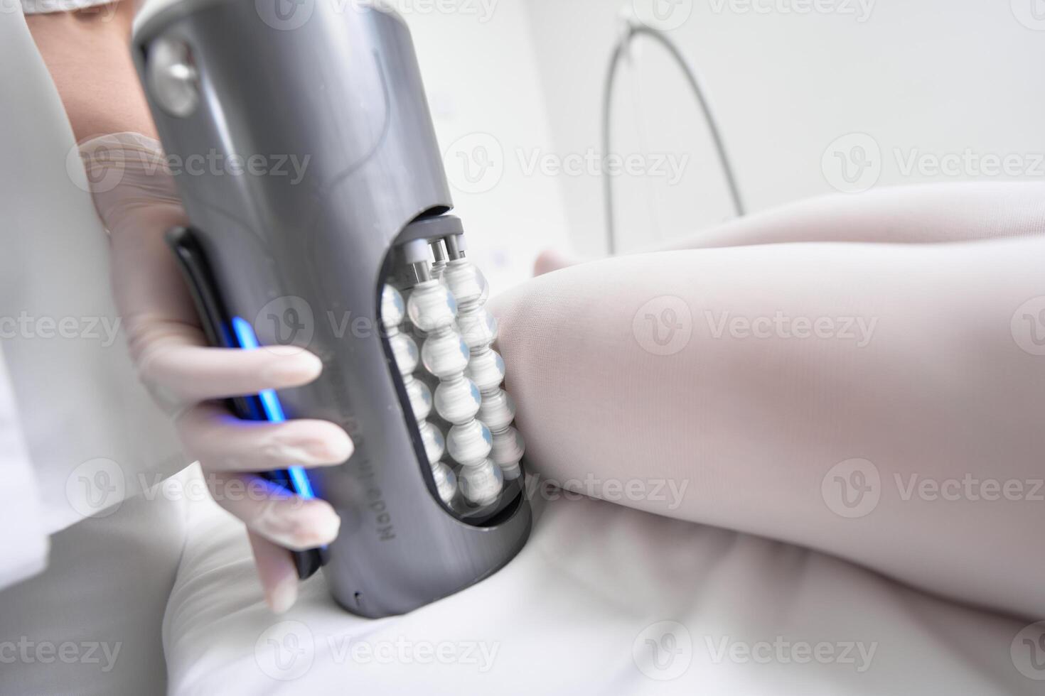 Advanced massage therapy device in use on a clients leg during a session photo