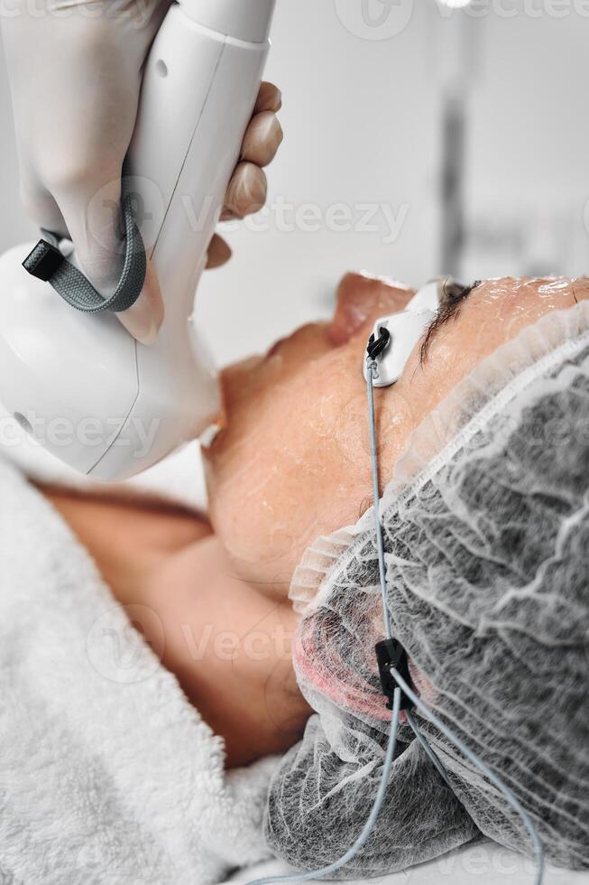 Aesthetic treatment session in a modern clinic during daytime photo