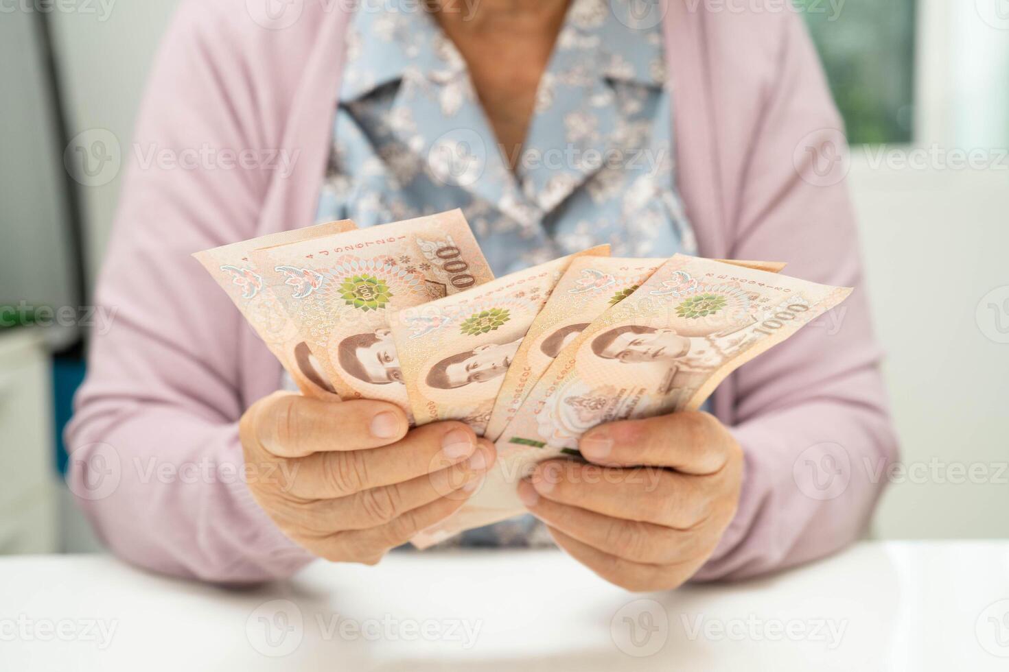 Retired elderly woman counting coins money and worry about monthly expenses and treatment fee payment. photo