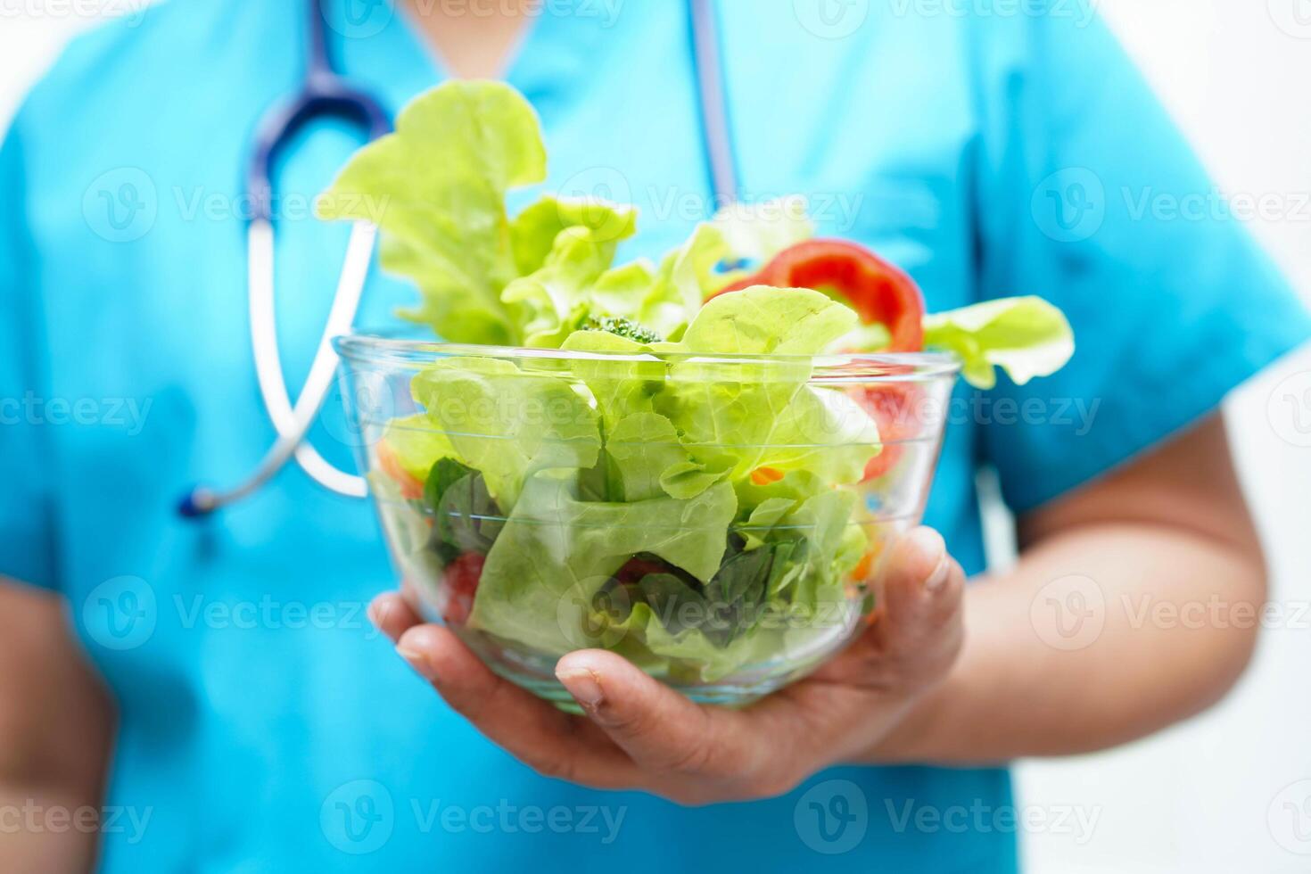 Asian Nutritionist holding healthy food for patient in hospital, nutrition and vitamin. photo