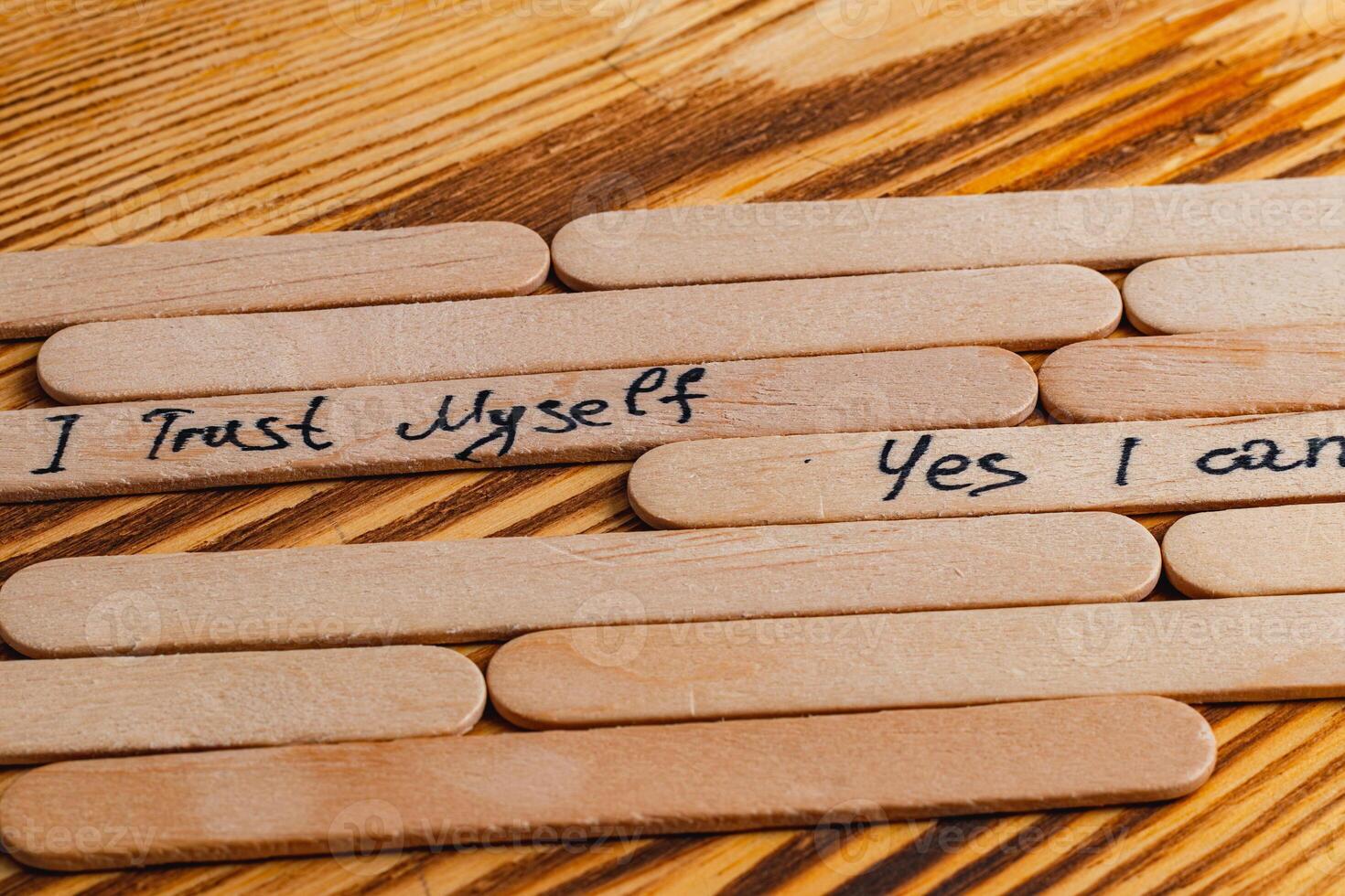 Positive thoughts for increasing selfesteem on wooden posts on wooden background photo